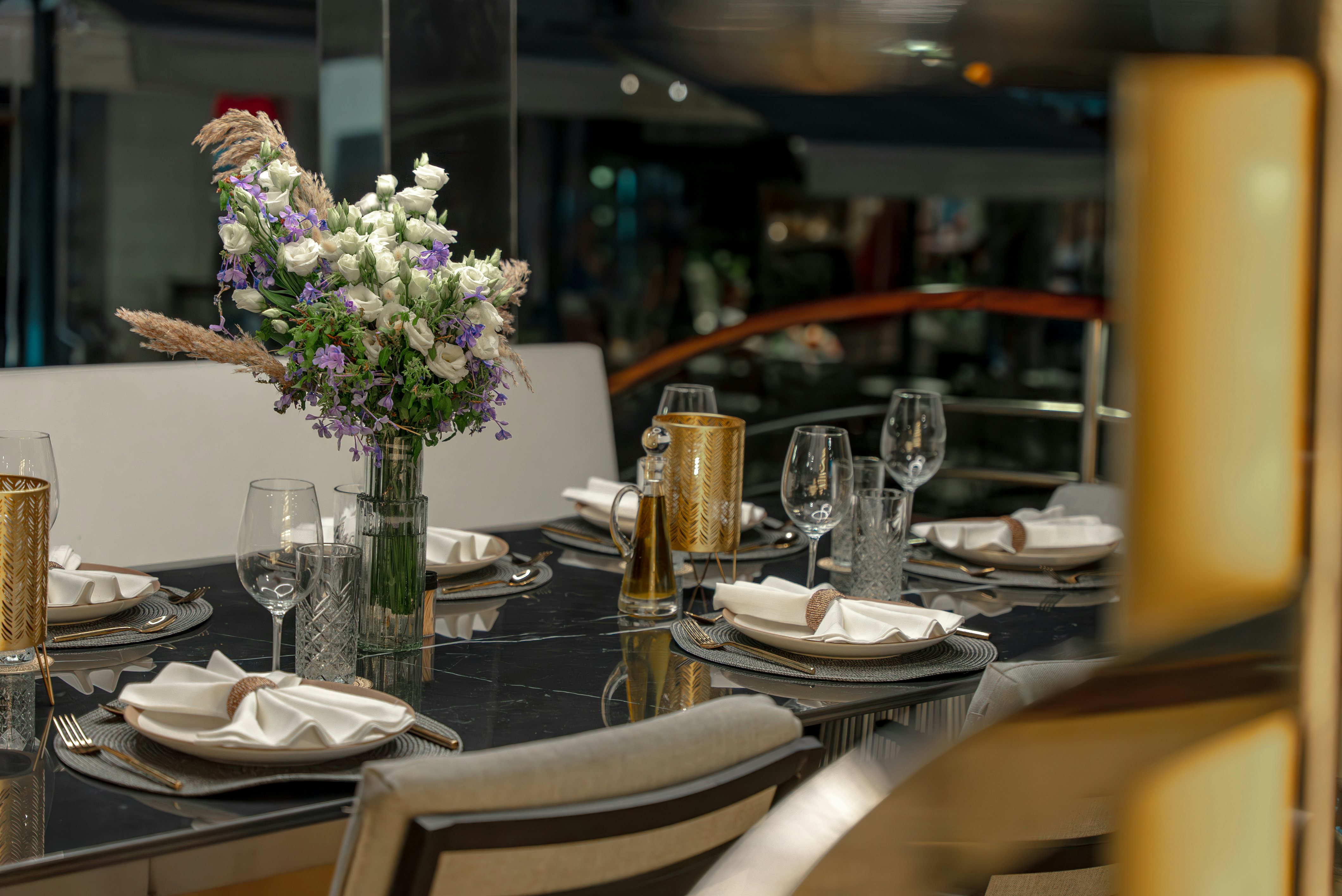 a table set with plates and glasses aboard SANTA CLARA Yacht for Charter