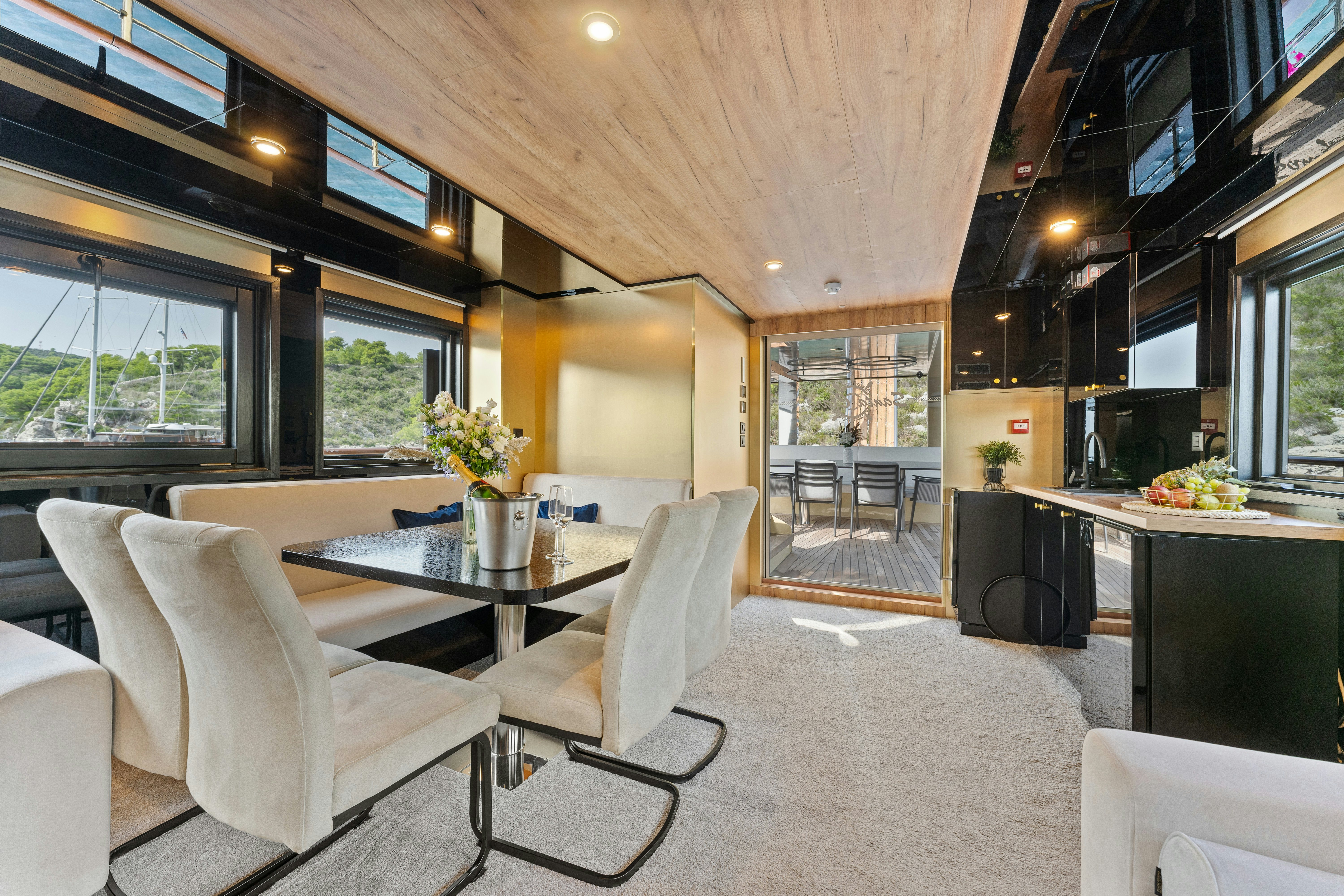 a room with a table chairs and a large window aboard SANTA CLARA Yacht for Charter