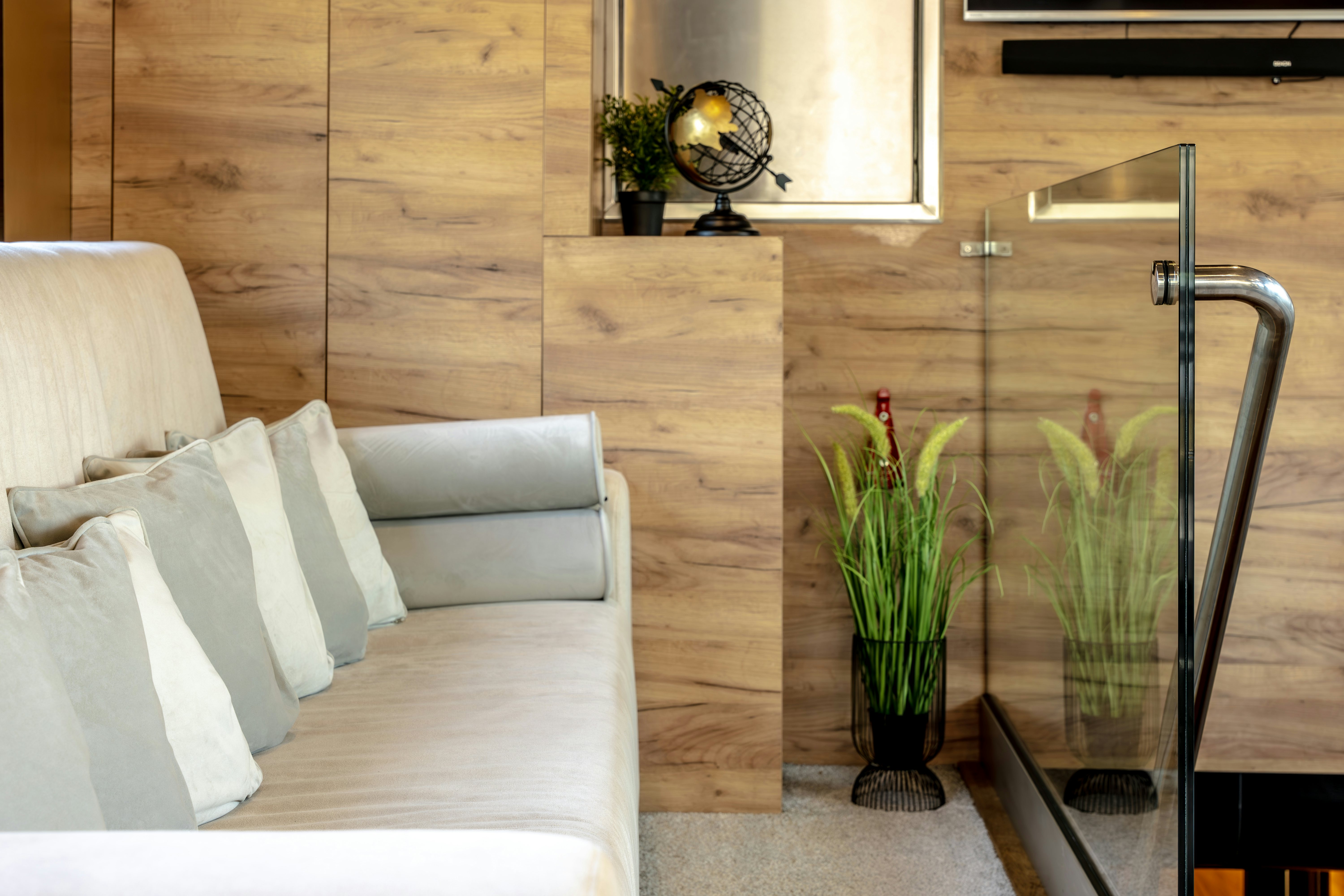 a room with a couch and a coffee table with a vase with plants aboard SANTA CLARA Yacht for Charter