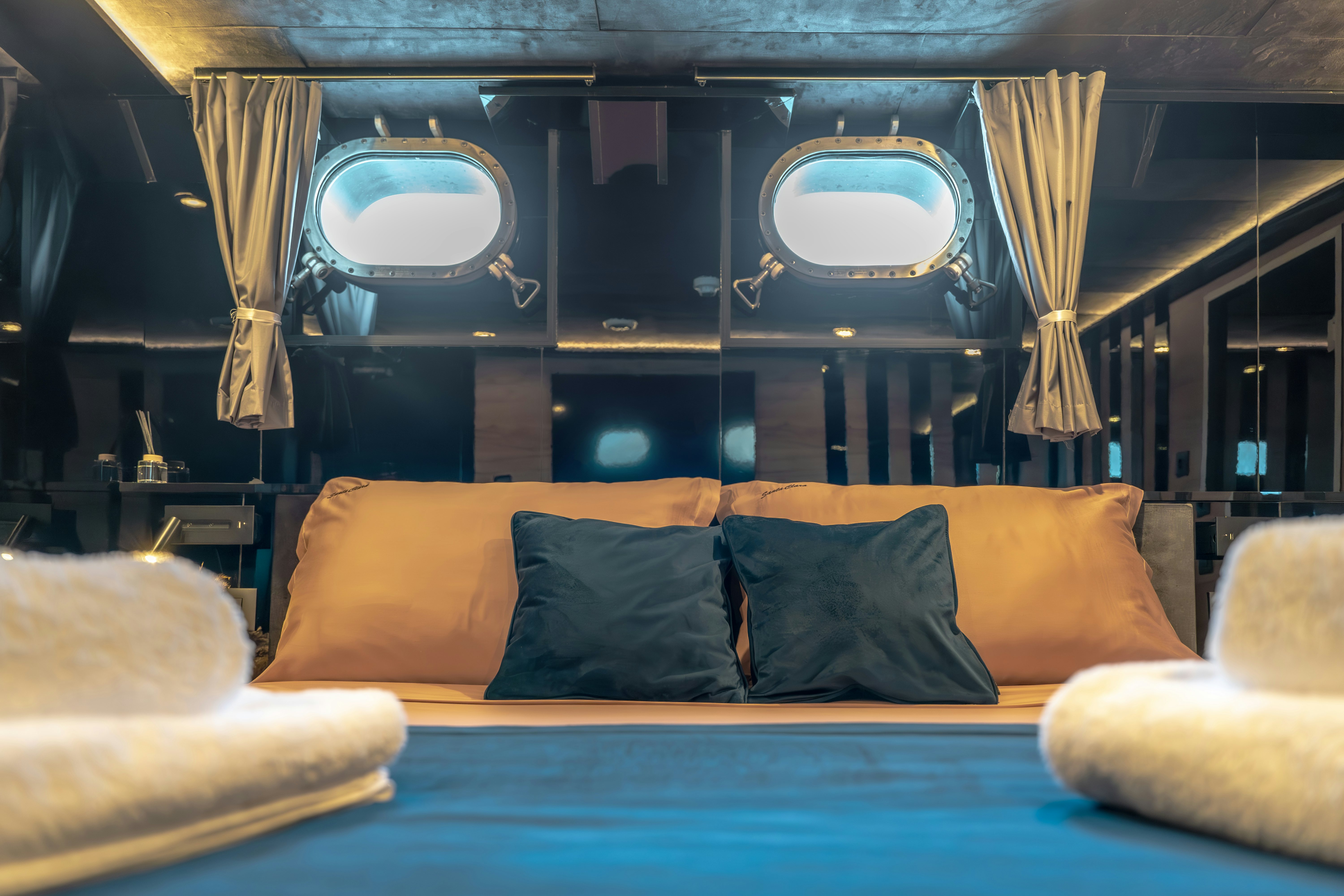 a bed with pillows and a mirror aboard SANTA CLARA Yacht for Charter