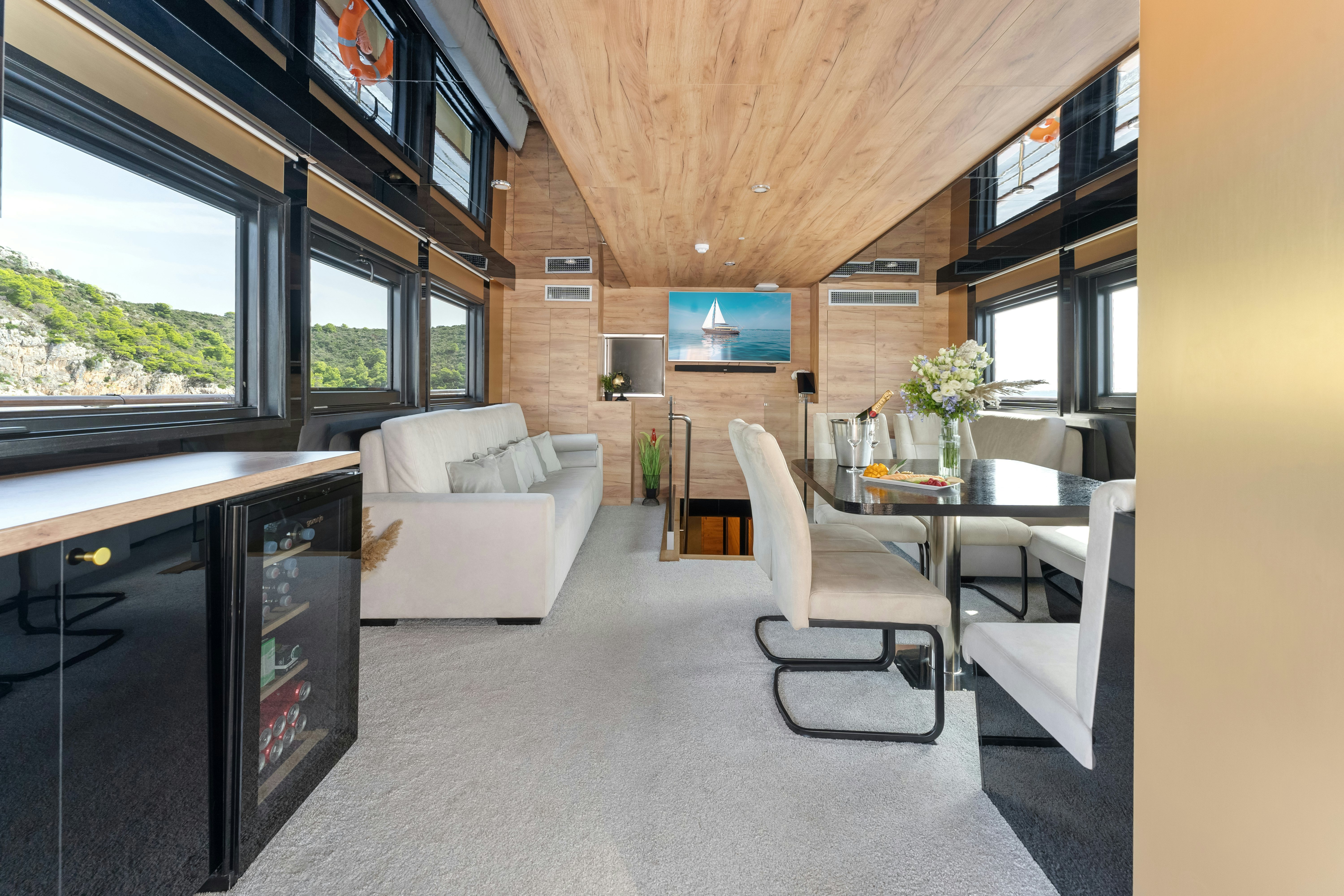 a living room with a table and chairs aboard SANTA CLARA Yacht for Charter