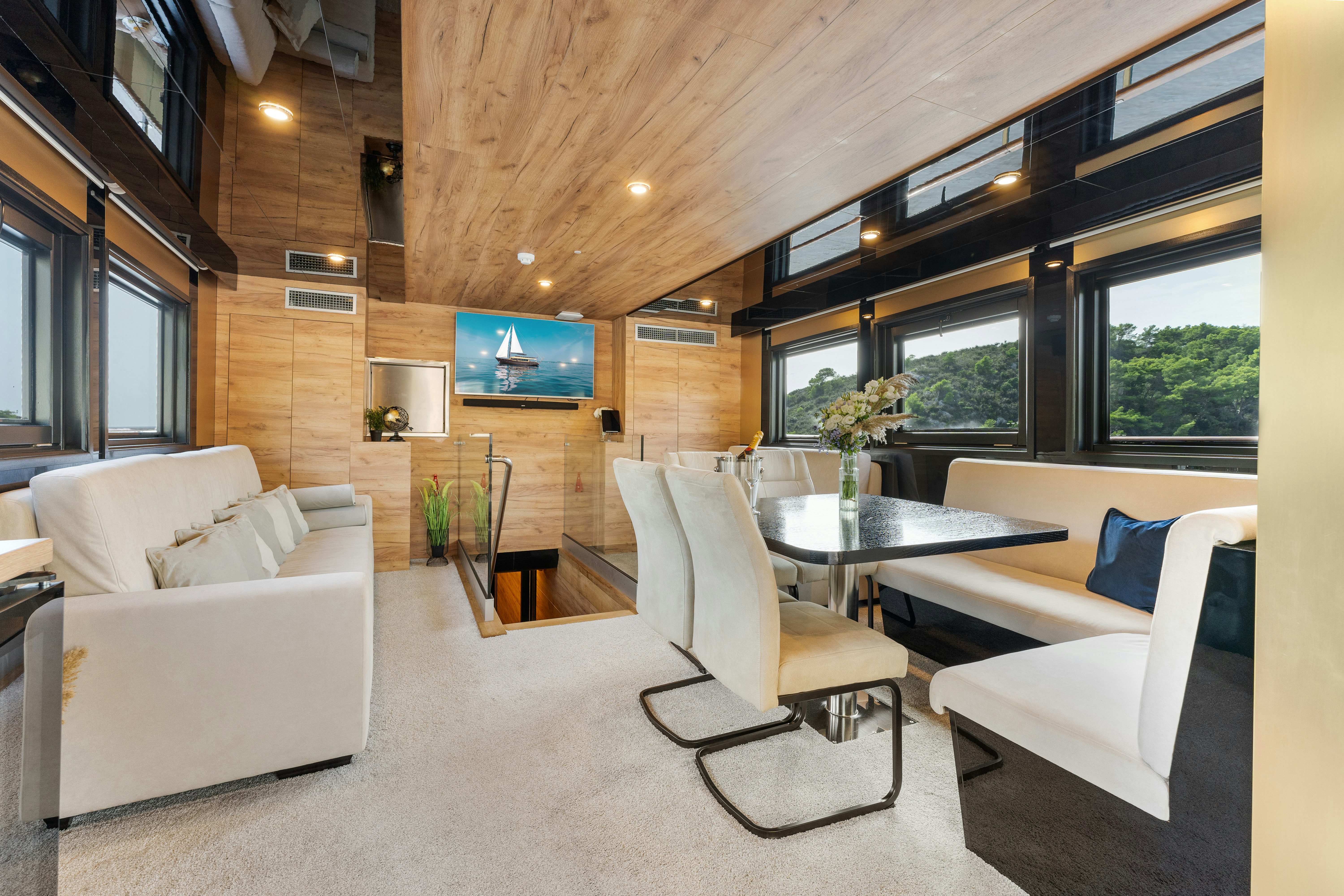 a living room with a table and chairs aboard SANTA CLARA Yacht for Charter