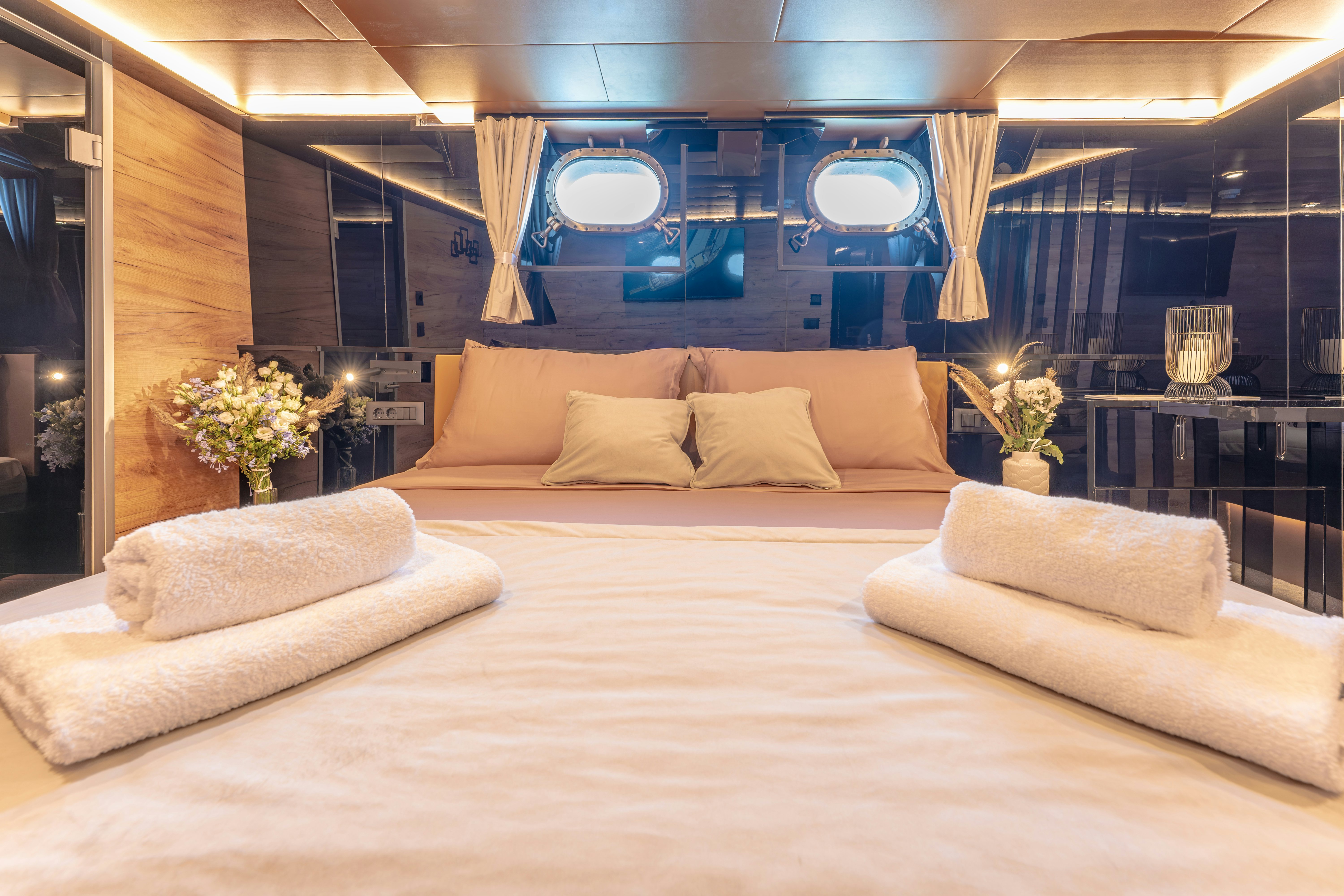 a room with a bed and a large window aboard SANTA CLARA Yacht for Charter