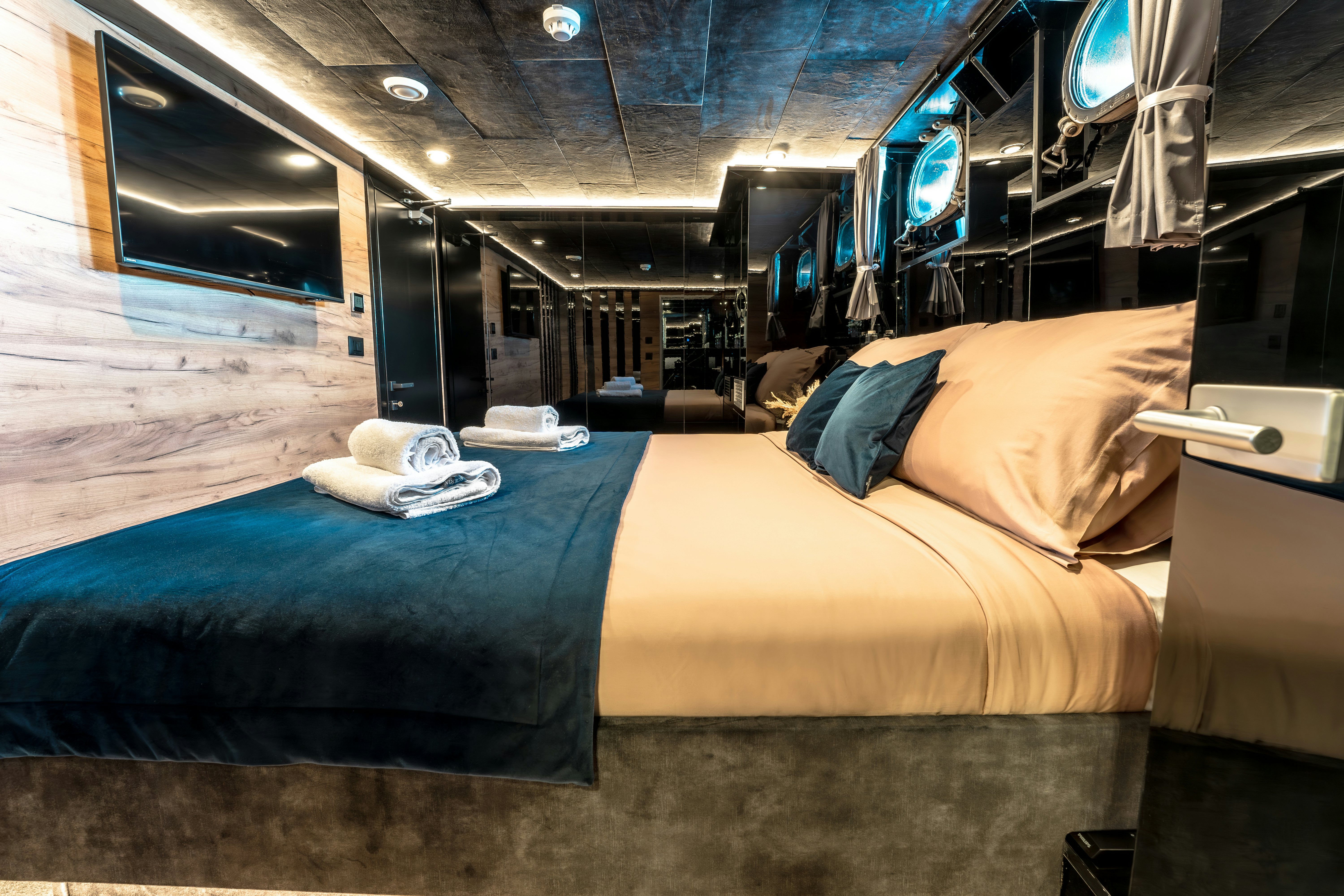 a room with beds and a window aboard SANTA CLARA Yacht for Charter