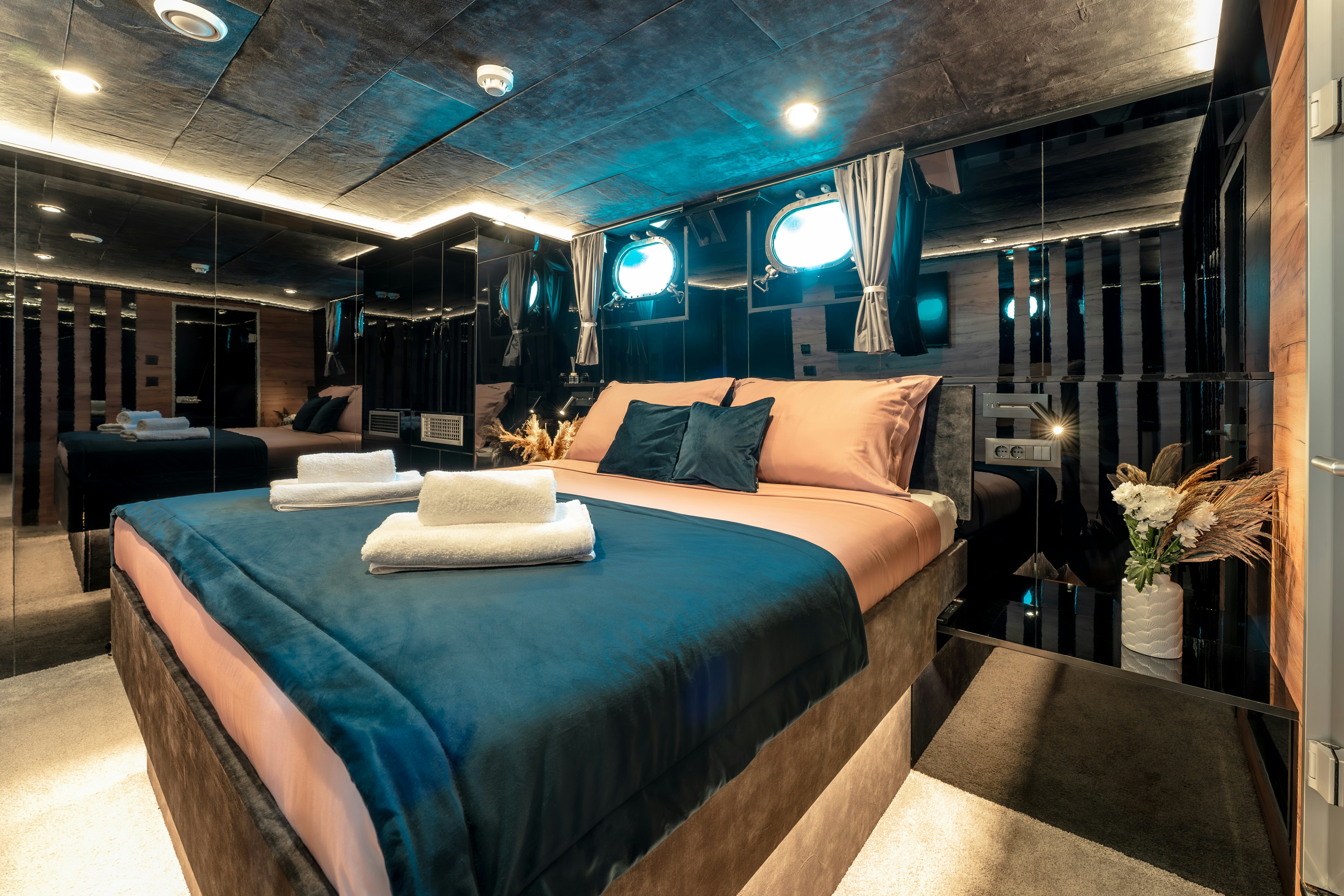 a room with a bed and a chair aboard SANTA CLARA Yacht for Charter