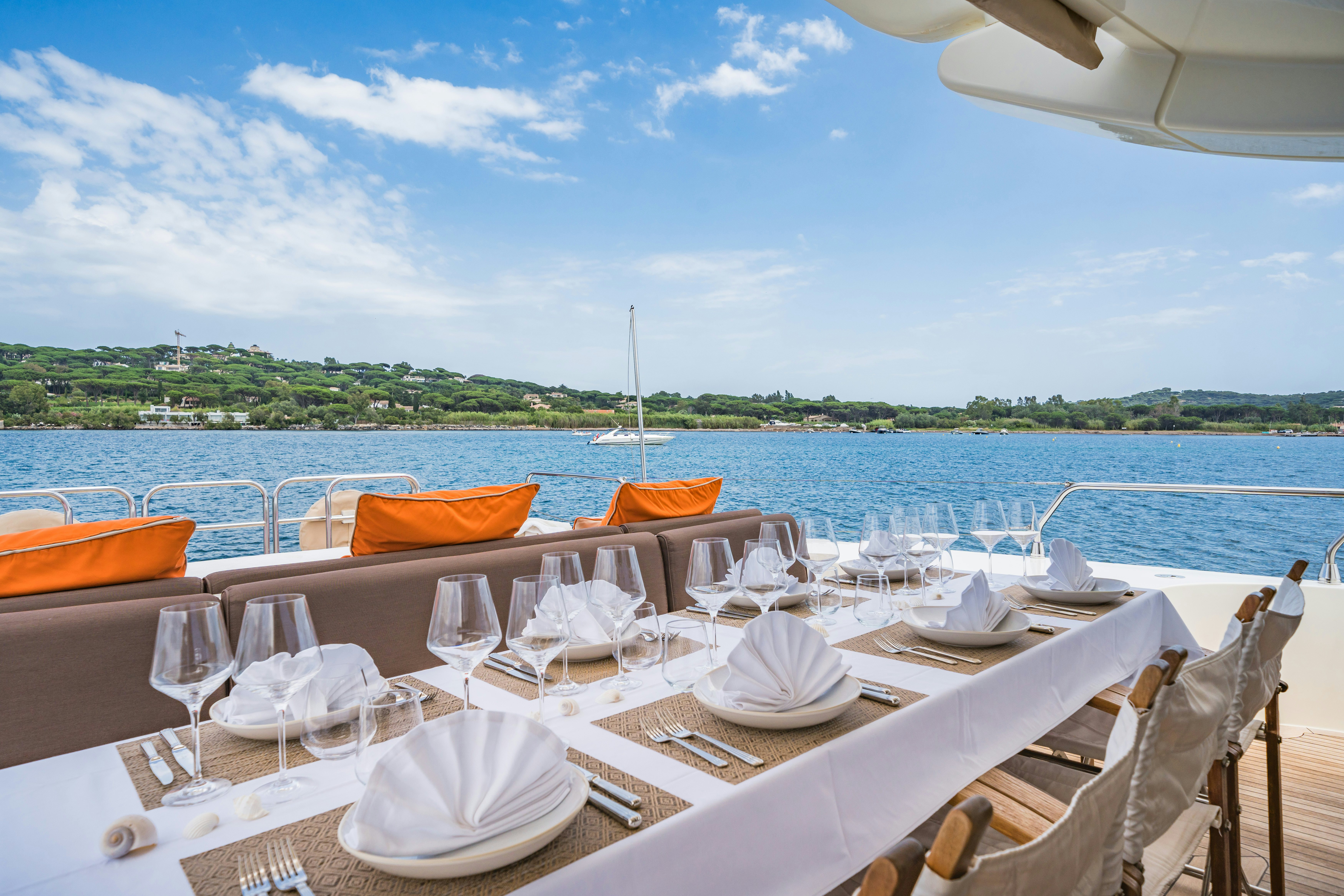 a table set for a dinner on a boat aboard ECLAT Yacht for Charter