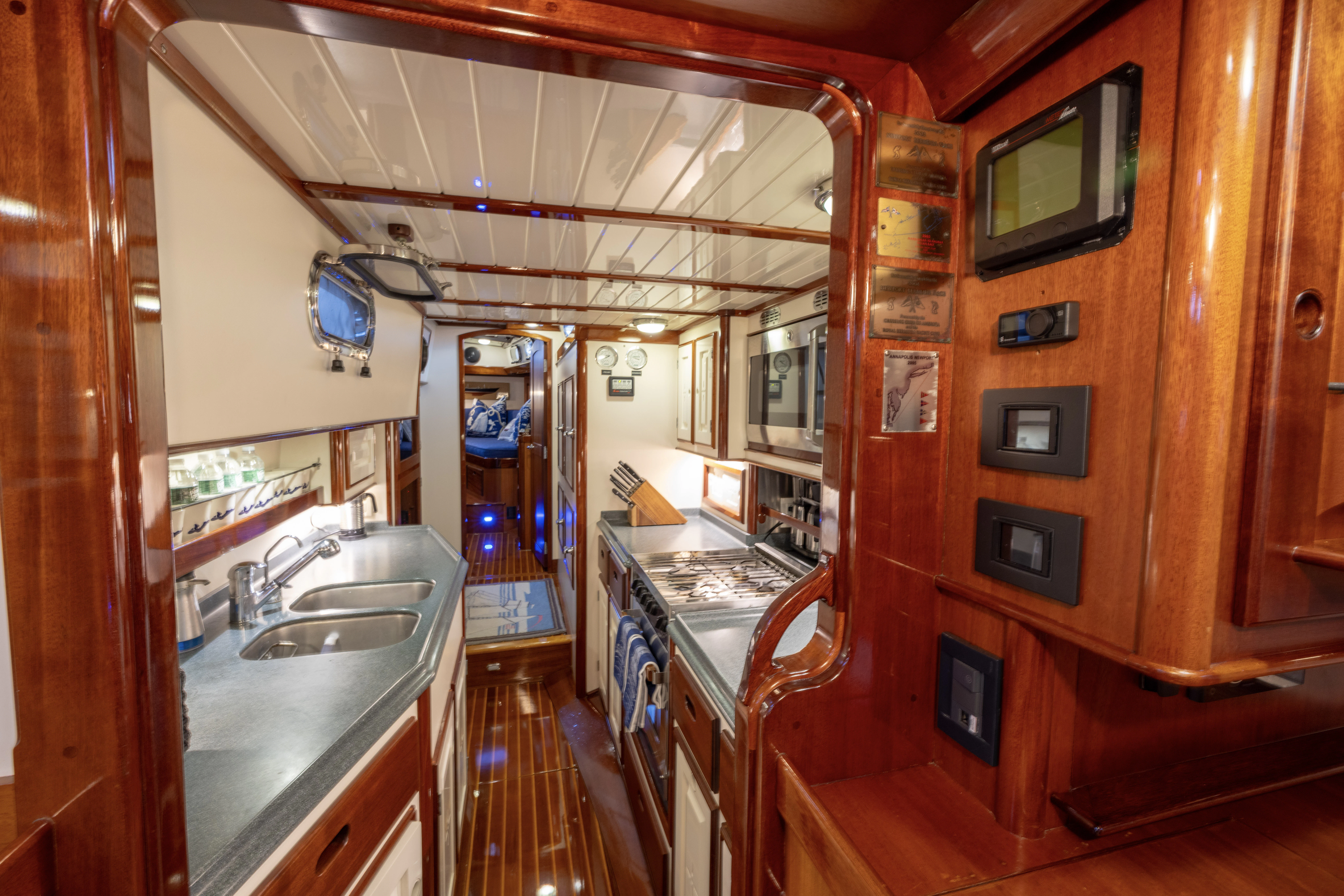 a kitchen with wooden cabinets aboard MYSTERY Yacht for Sale