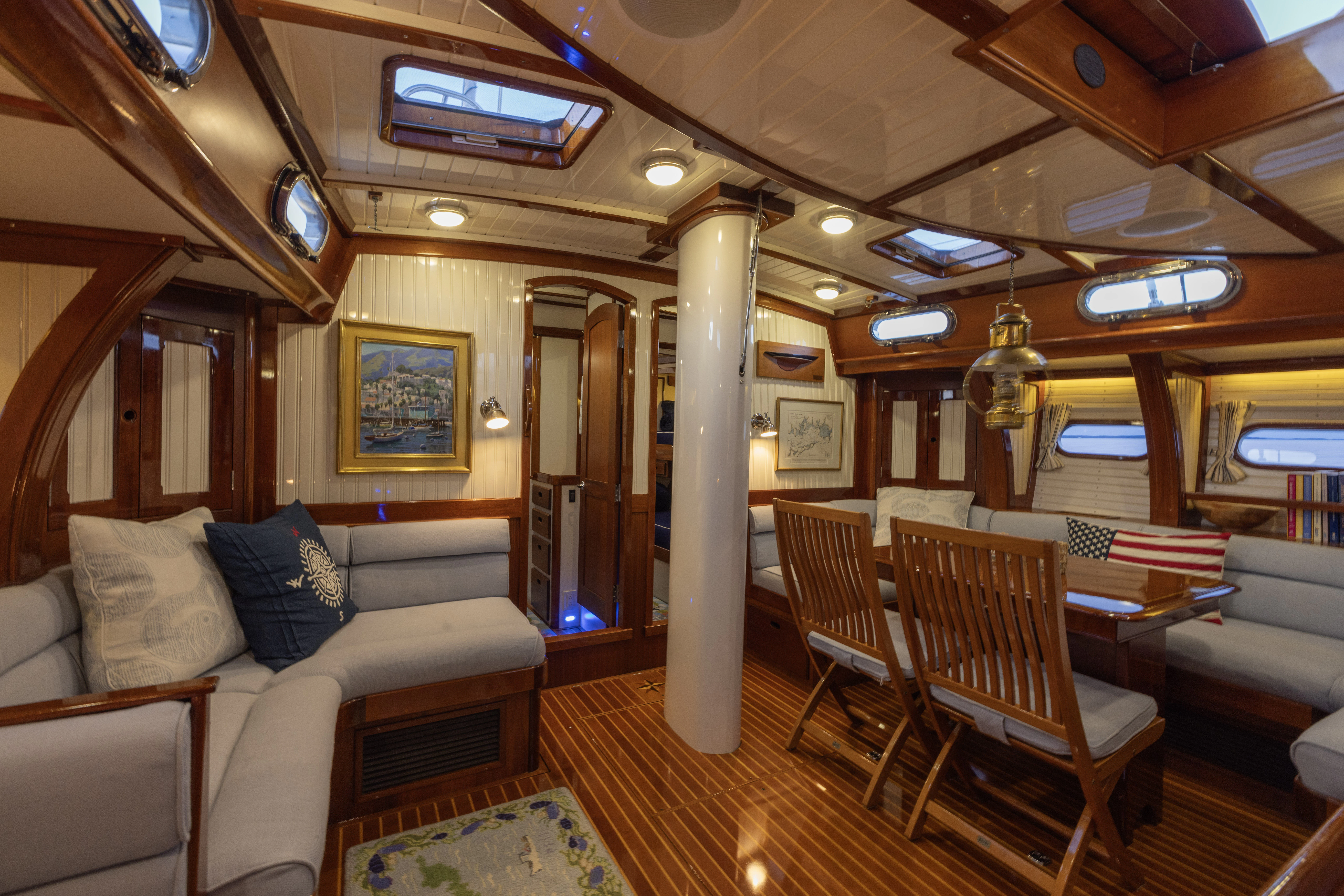 a train car with a couch and chairs aboard MYSTERY Yacht for Sale