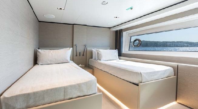 a room with beds and a window aboard HAIAMI I Yacht for Charter