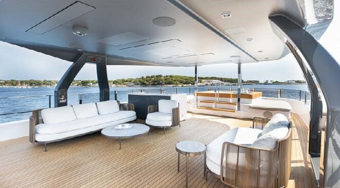 a large lounge area with a large patio and a large body of water aboard HAIAMI I Yacht for Charter