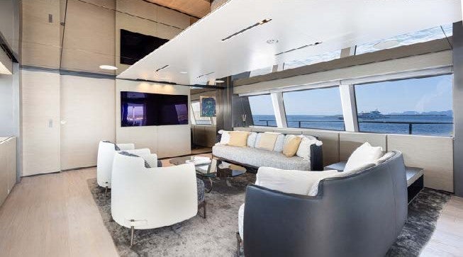 a living room with a couch and a tv aboard HAIAMI I Yacht for Charter