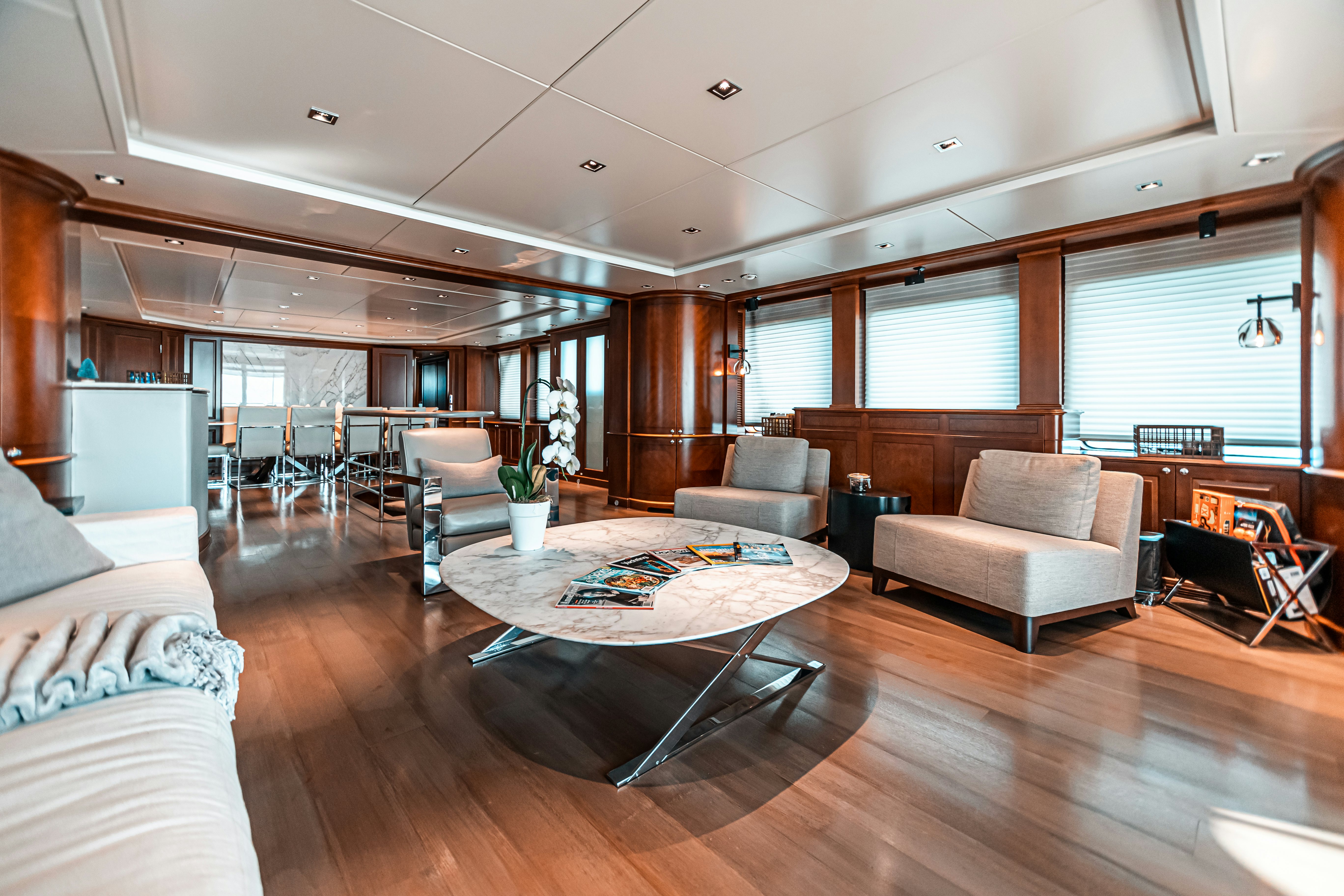 a living room with a wood floor aboard ARTHUR’S WAY Yacht for Charter