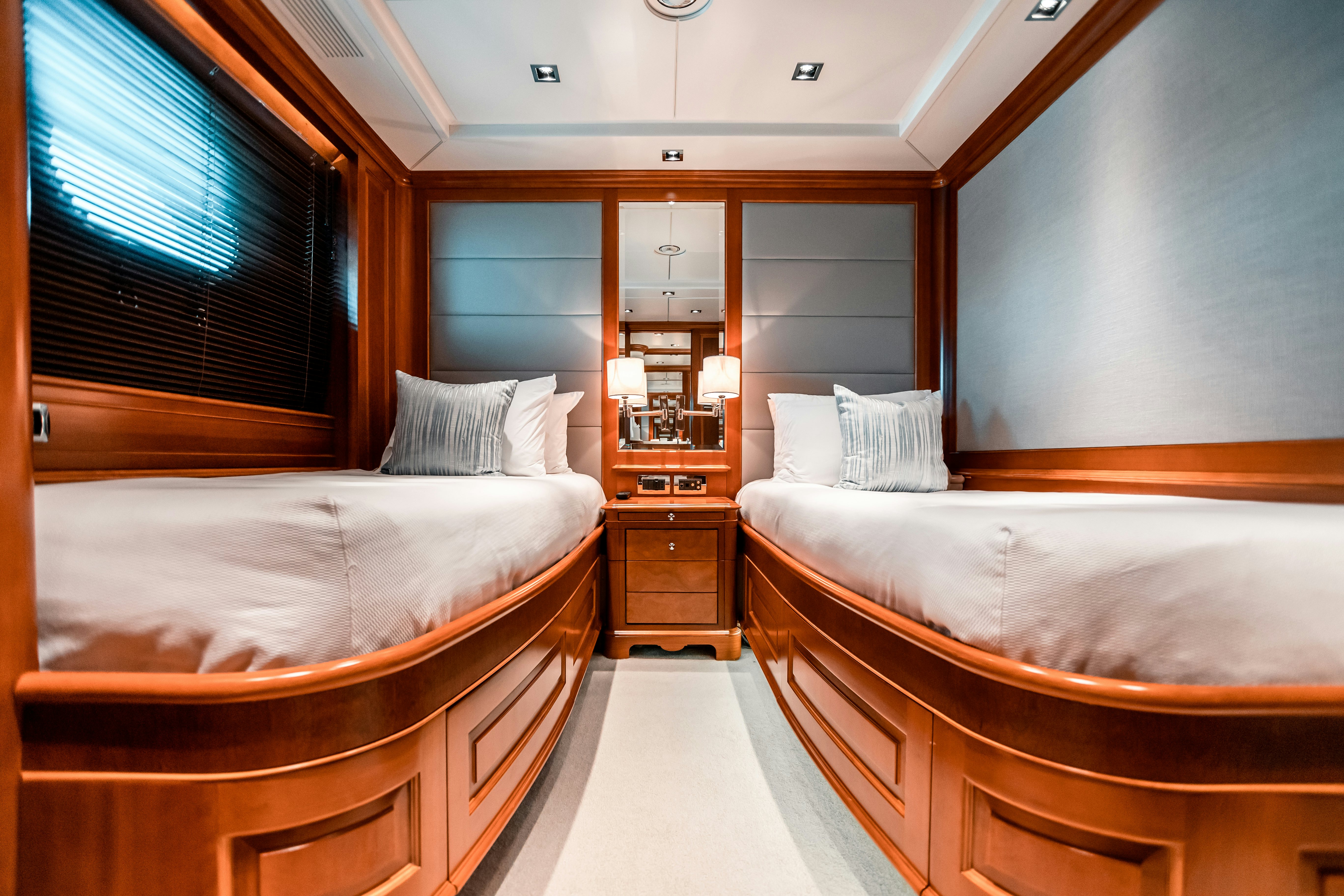 a room with a bed and a window aboard ARTHUR’S WAY Yacht for Charter