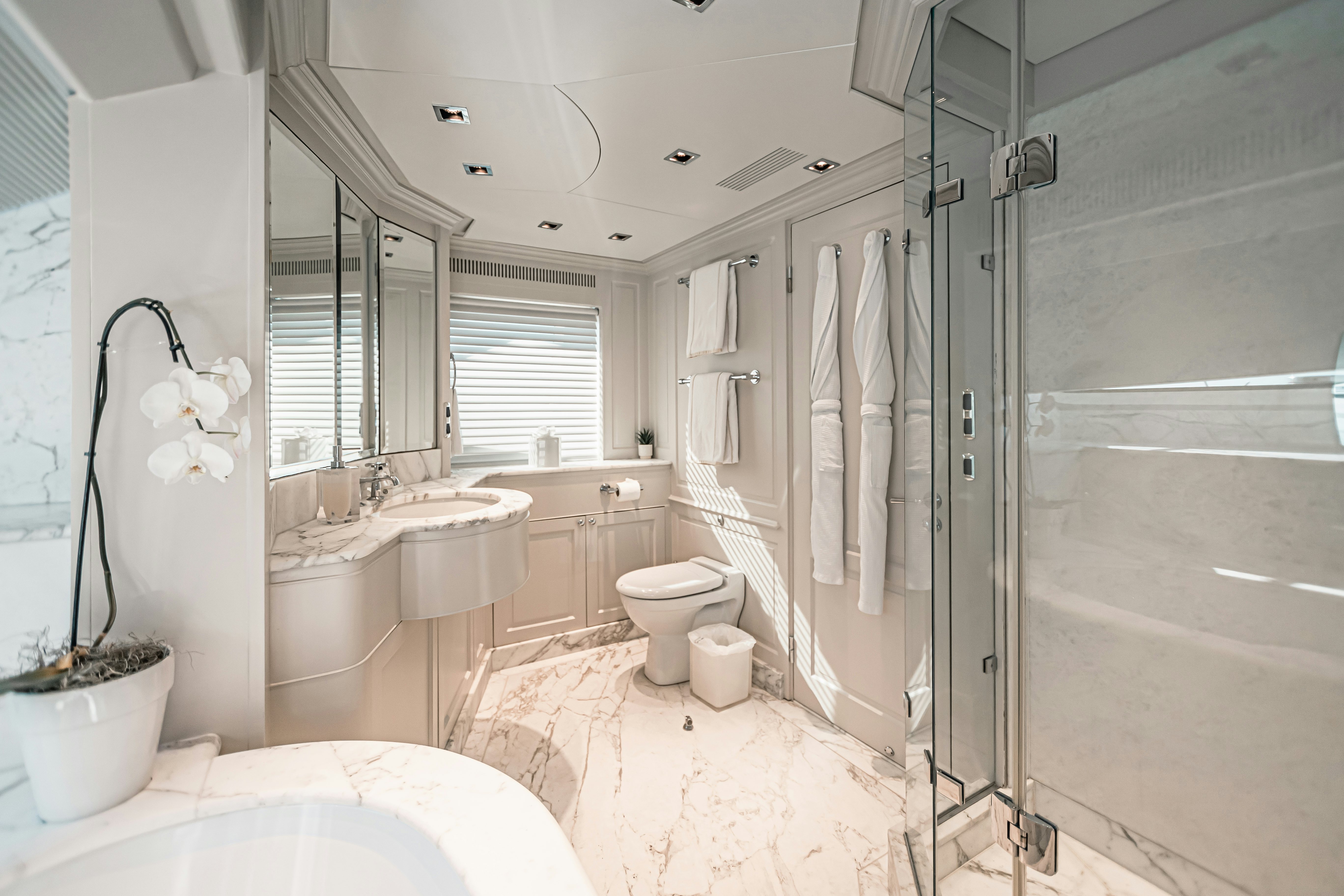 a bathroom with a tub sink and toilet aboard ARTHUR’S WAY Yacht for Charter