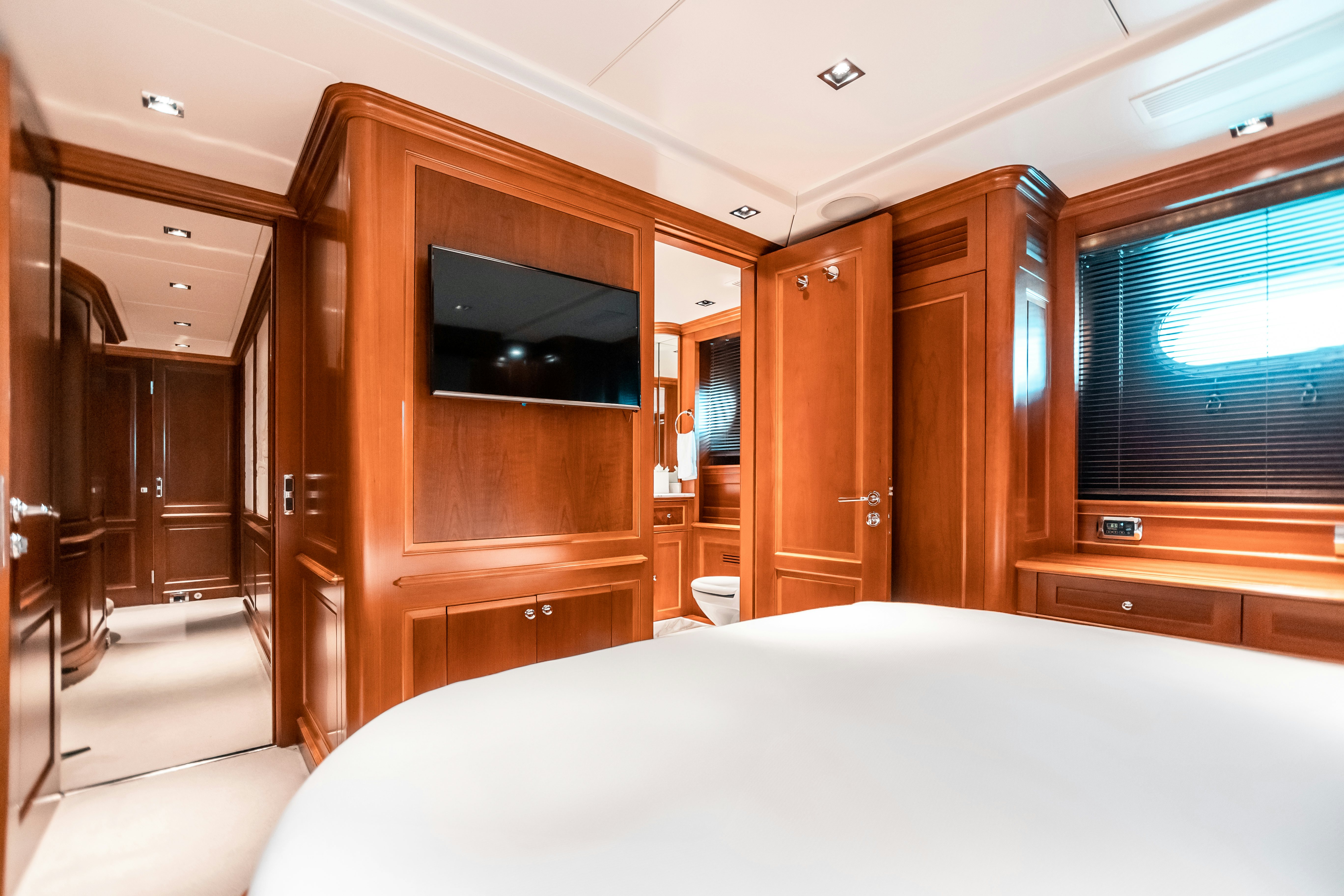 a bedroom with a bed and a television aboard ARTHUR’S WAY Yacht for Charter
