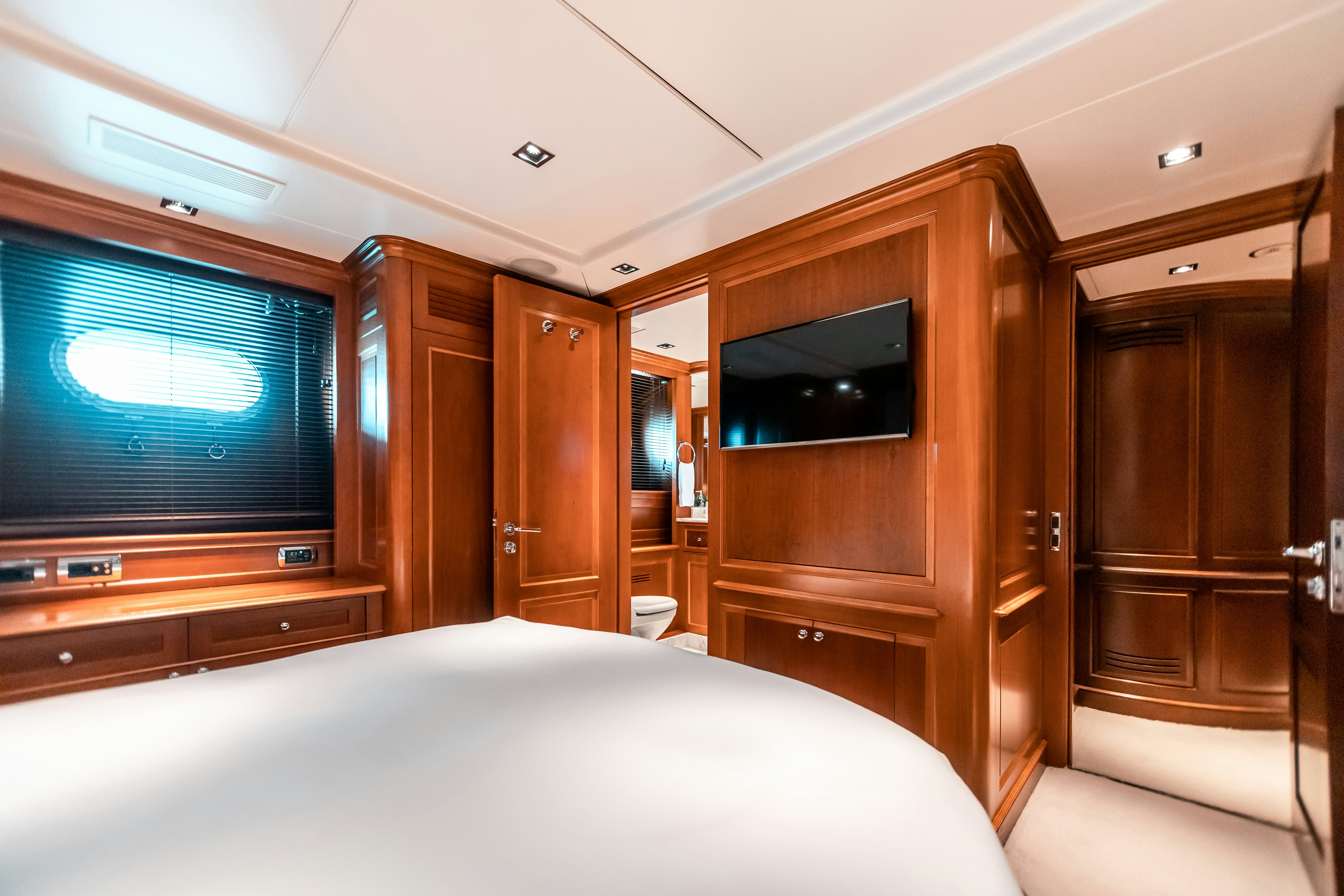 a bedroom with a bed and a television aboard ARTHUR’S WAY Yacht for Charter