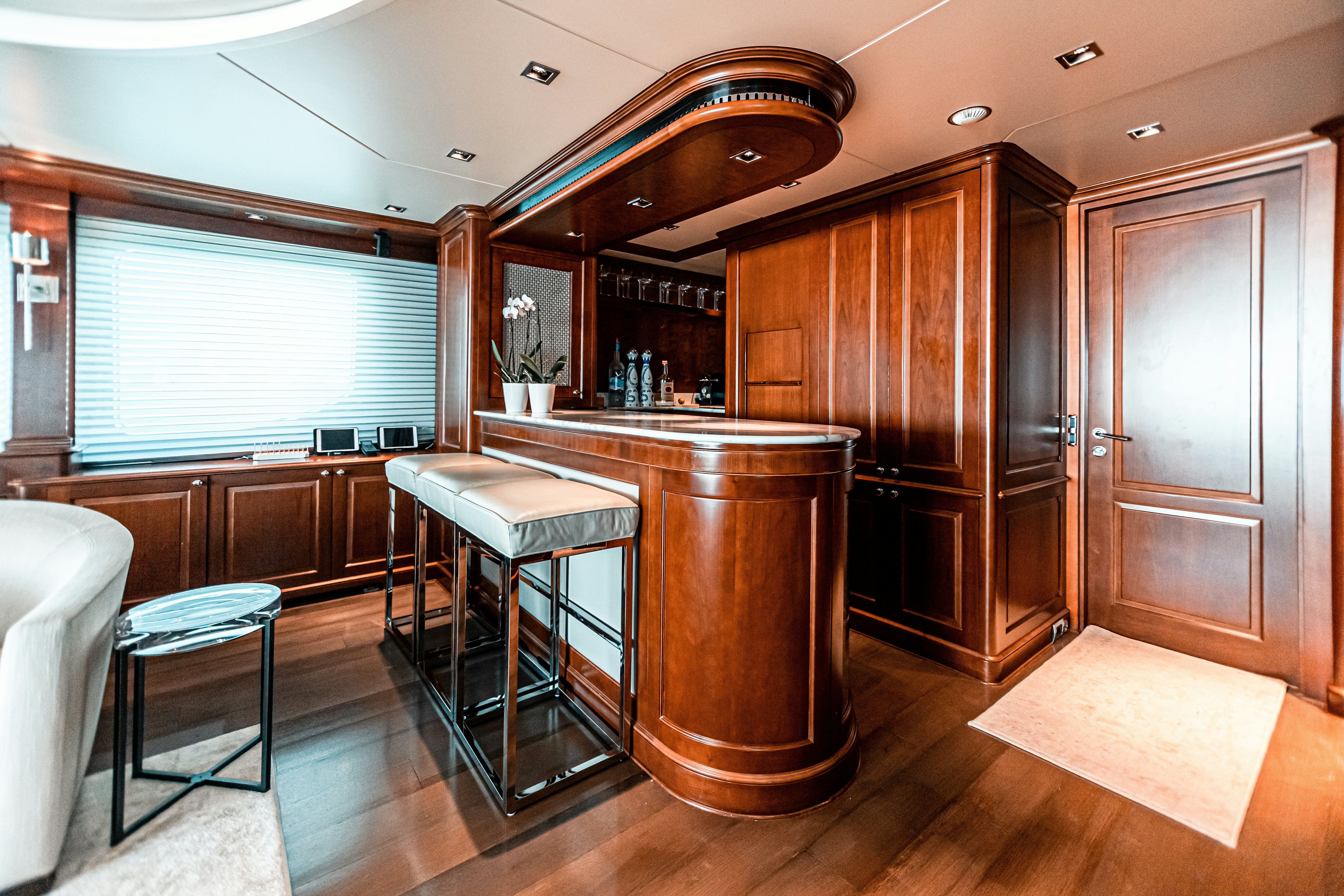 a kitchen with a bar and stools aboard ARTHUR’S WAY Yacht for Charter