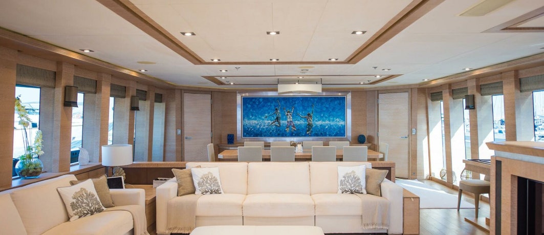a large living room with a large screen aboard NORMA JEAN Yacht for Charter
