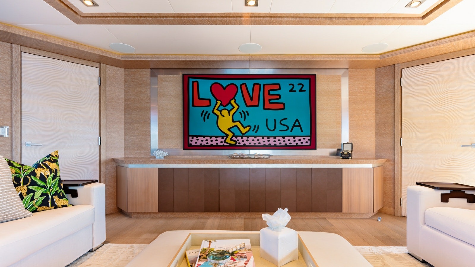 a room with a tv and furniture aboard NORMA JEAN Yacht for Charter