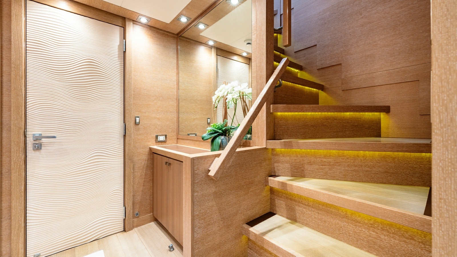 a wooden staircase with a white door aboard NORMA JEAN Yacht for Charter