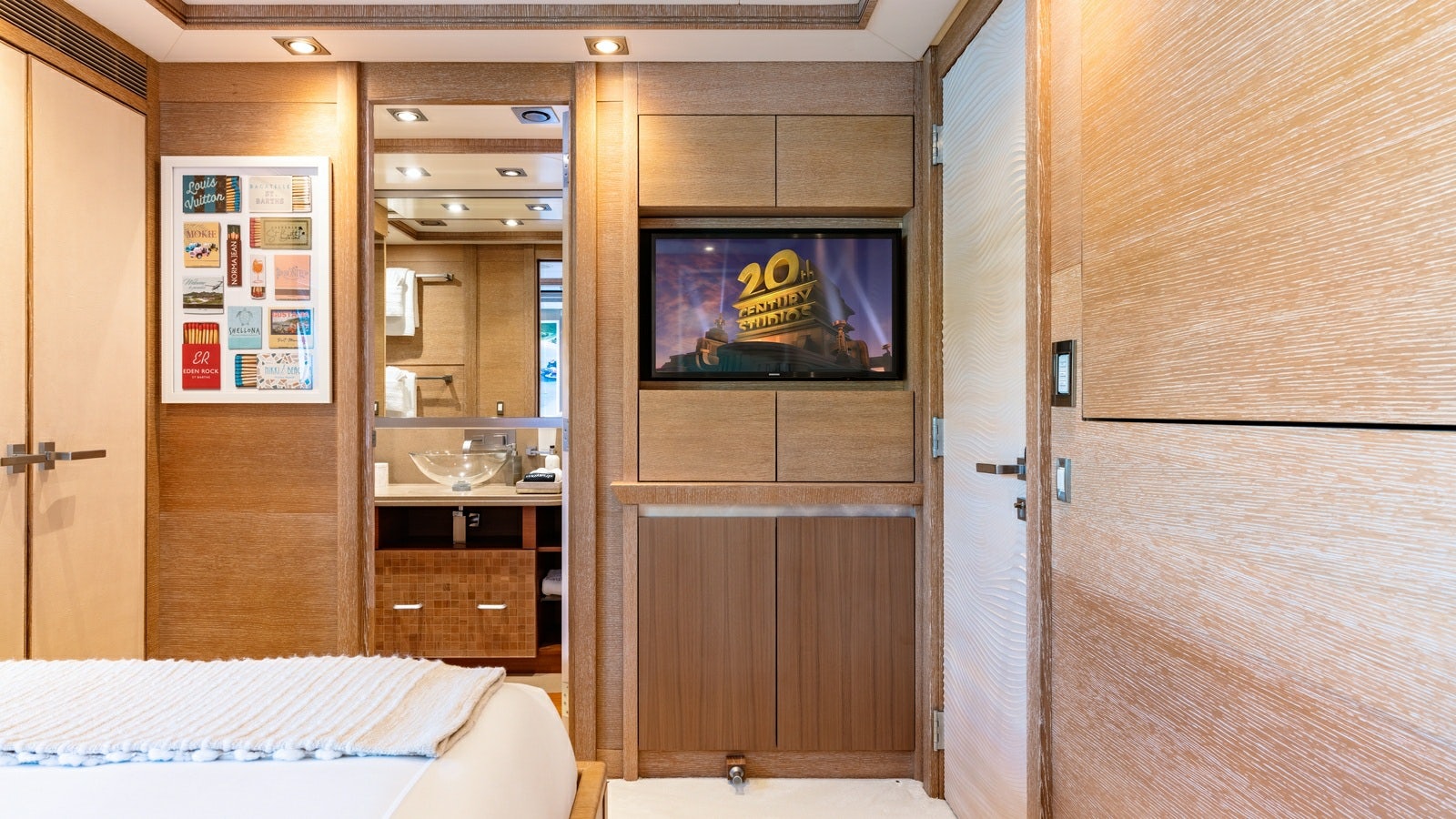 a tv on a wall in a room with wood cabinets aboard NORMA JEAN Yacht for Charter