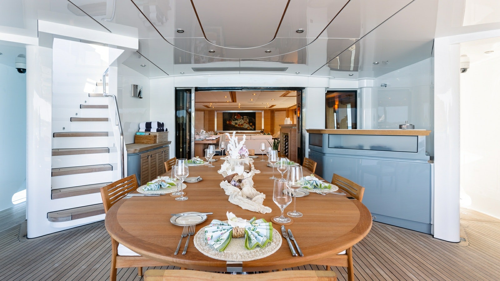 a dining table with a cake and wine glasses aboard NORMA JEAN Yacht for Charter