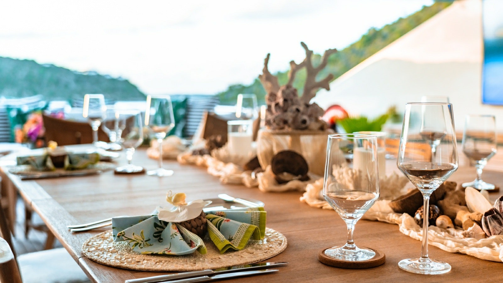 a table with wine glasses and food aboard NORMA JEAN Yacht for Charter