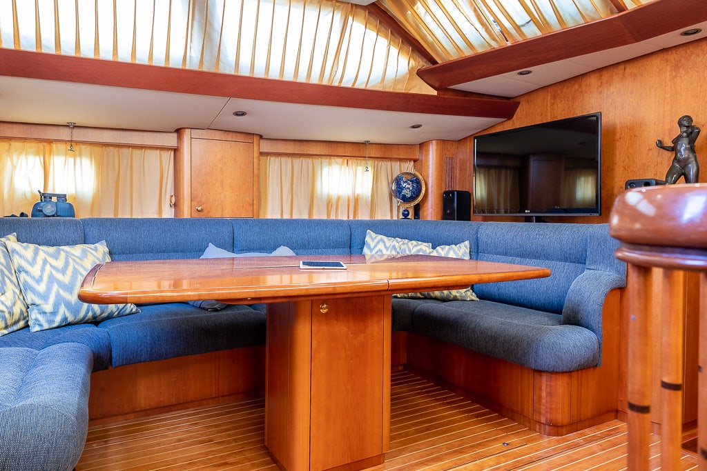 a living room with a couch and a table aboard JULIA Yacht for Sale
