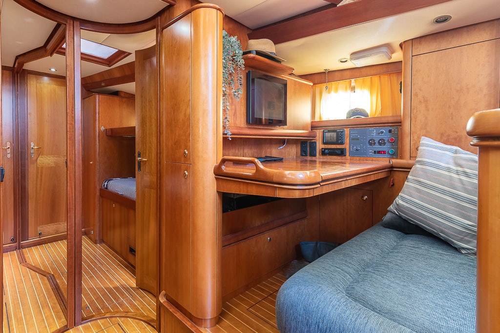 a cabin with a bed and a sink aboard JULIA Yacht for Sale