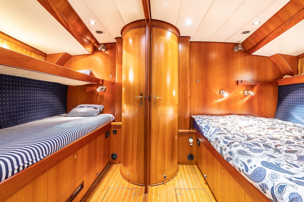 a bedroom with a bed and a closet aboard JULIA Yacht for Sale