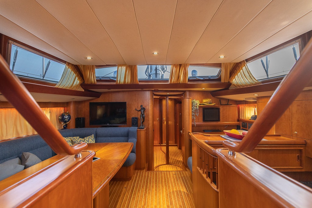 a room with a wood floor and a wood staircase aboard JULIA Yacht for Sale