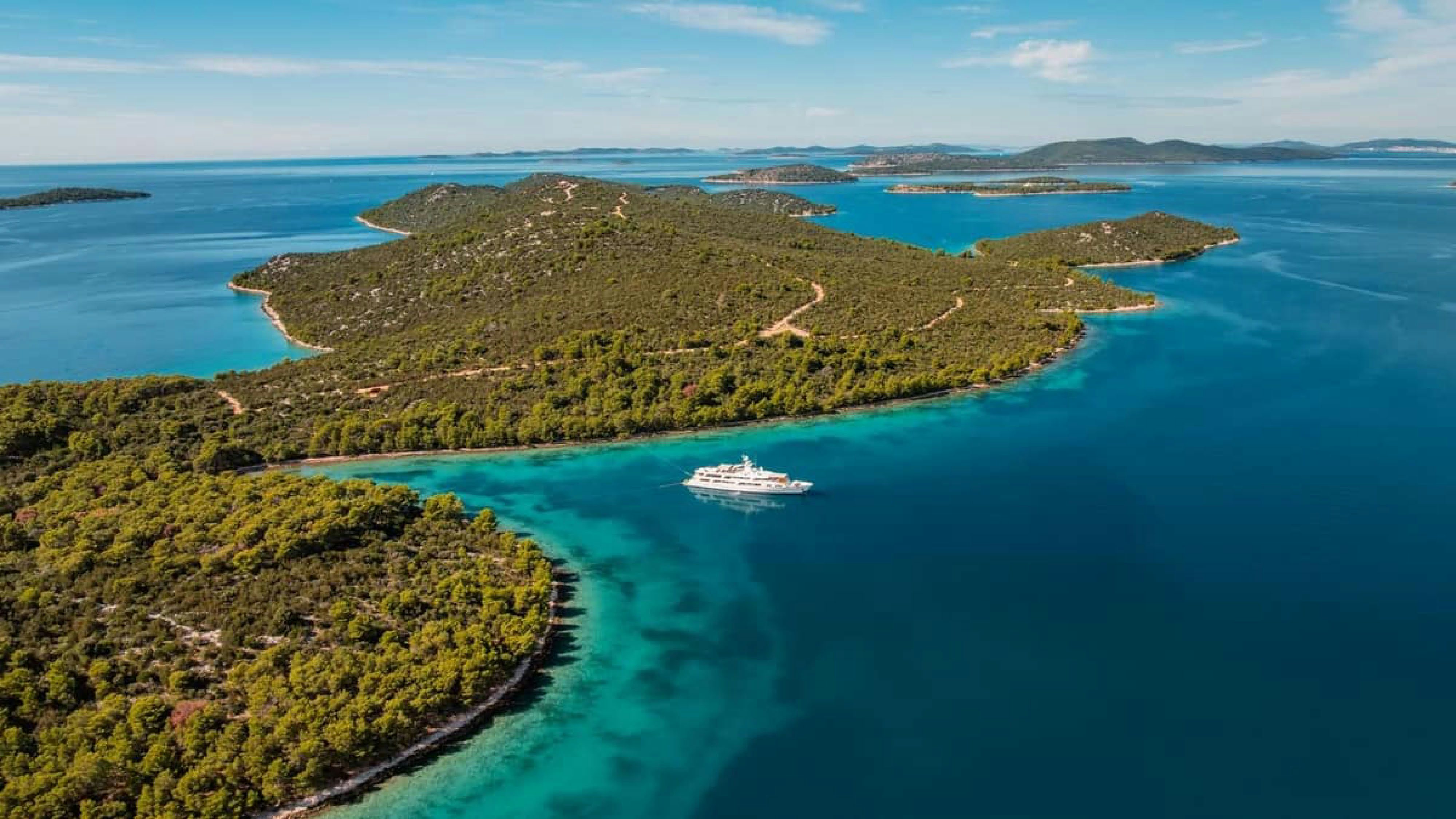 a body of water with land around it and a land with a boat on it aboard VICTORY Yacht for Charter