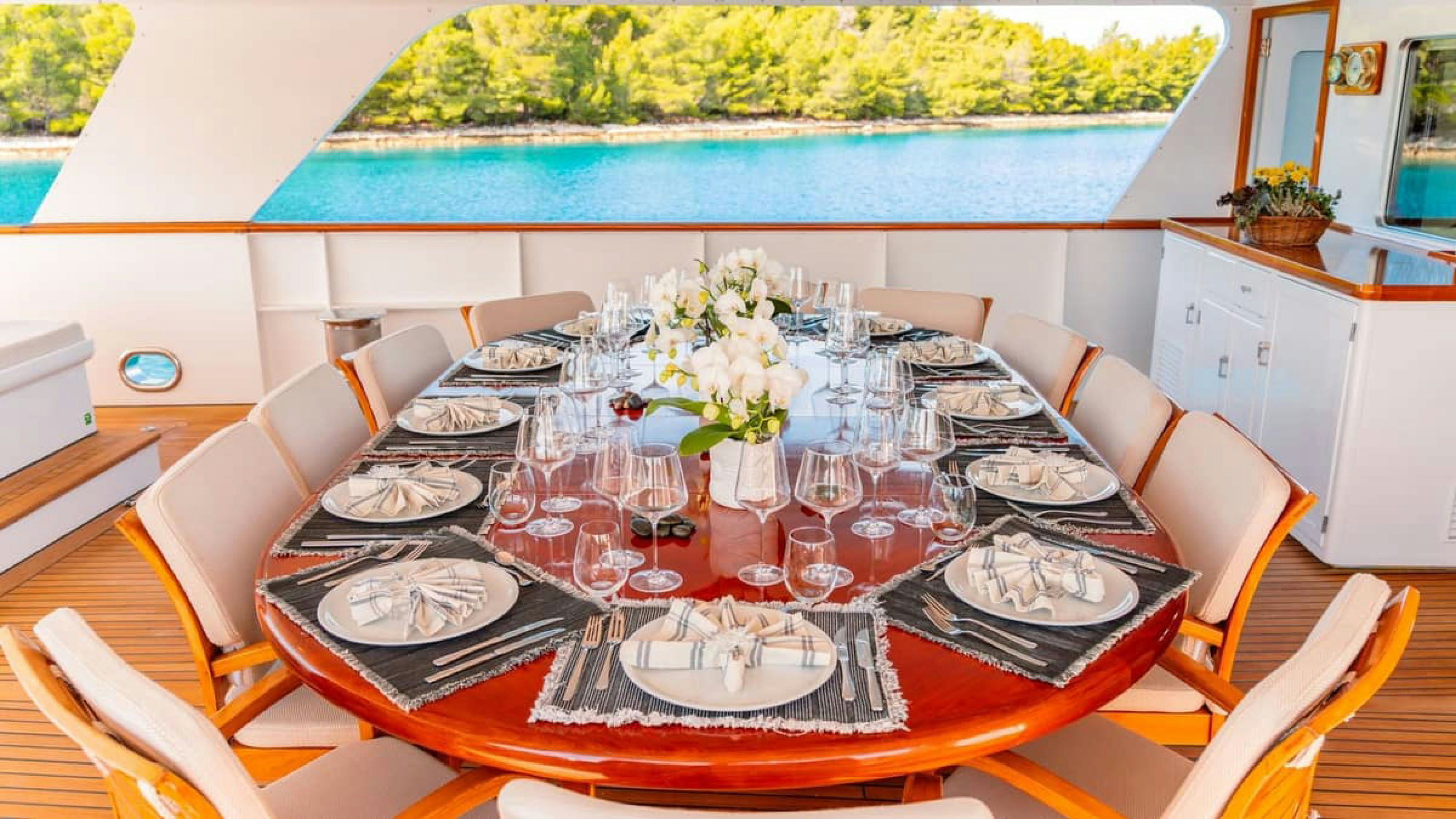 a table set with plates and glasses aboard VICTORY Yacht for Charter