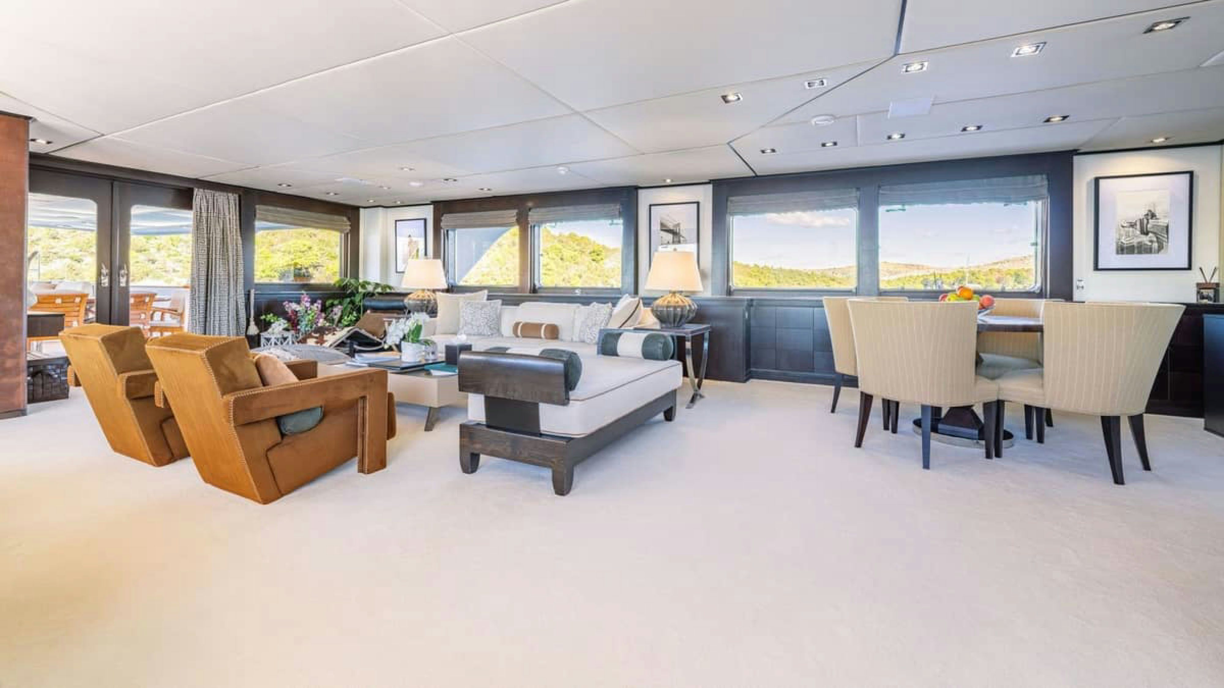 a large living room with a large window aboard VICTORY Yacht for Charter