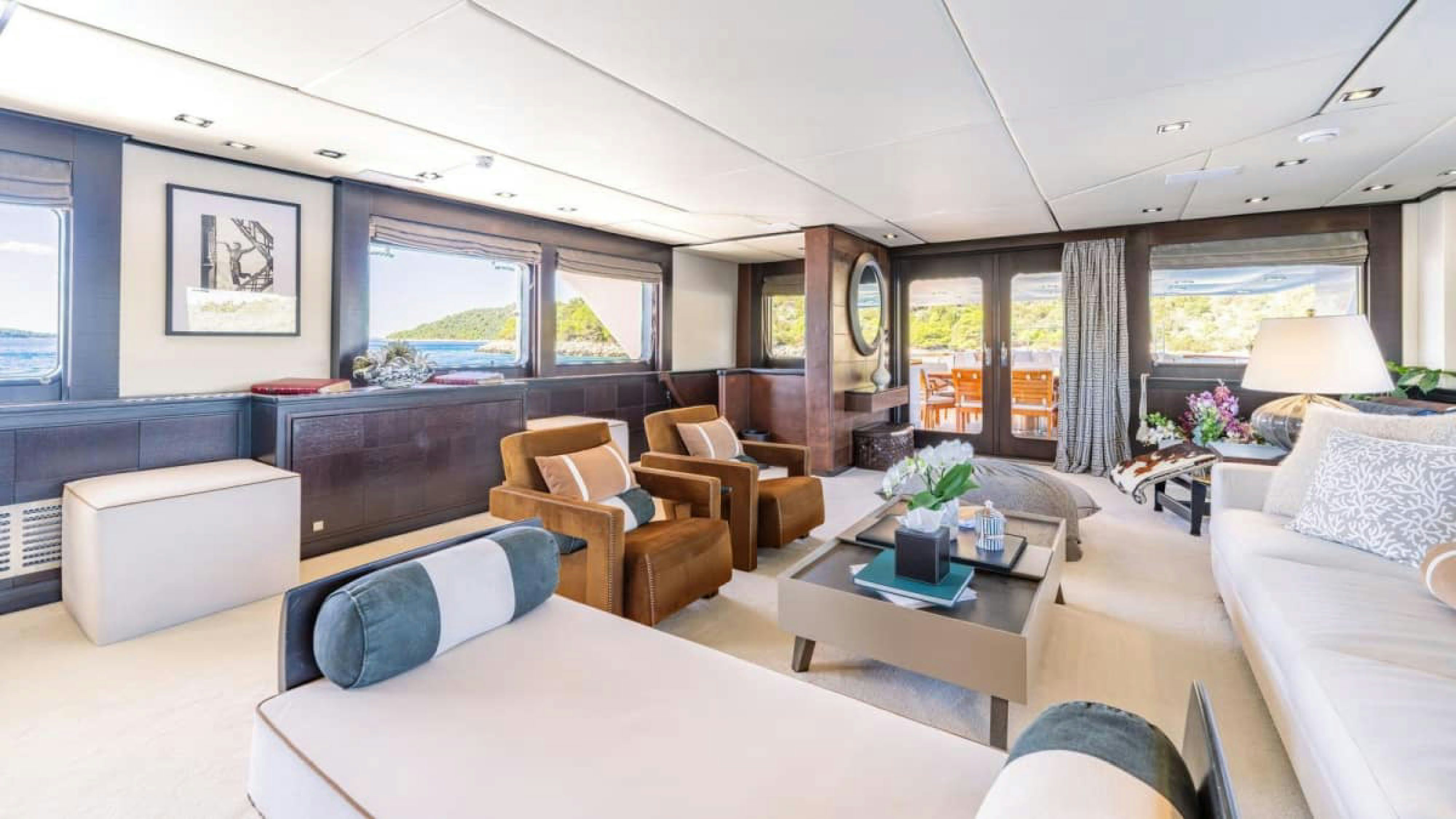 a large living room with a large window aboard VICTORY Yacht for Charter