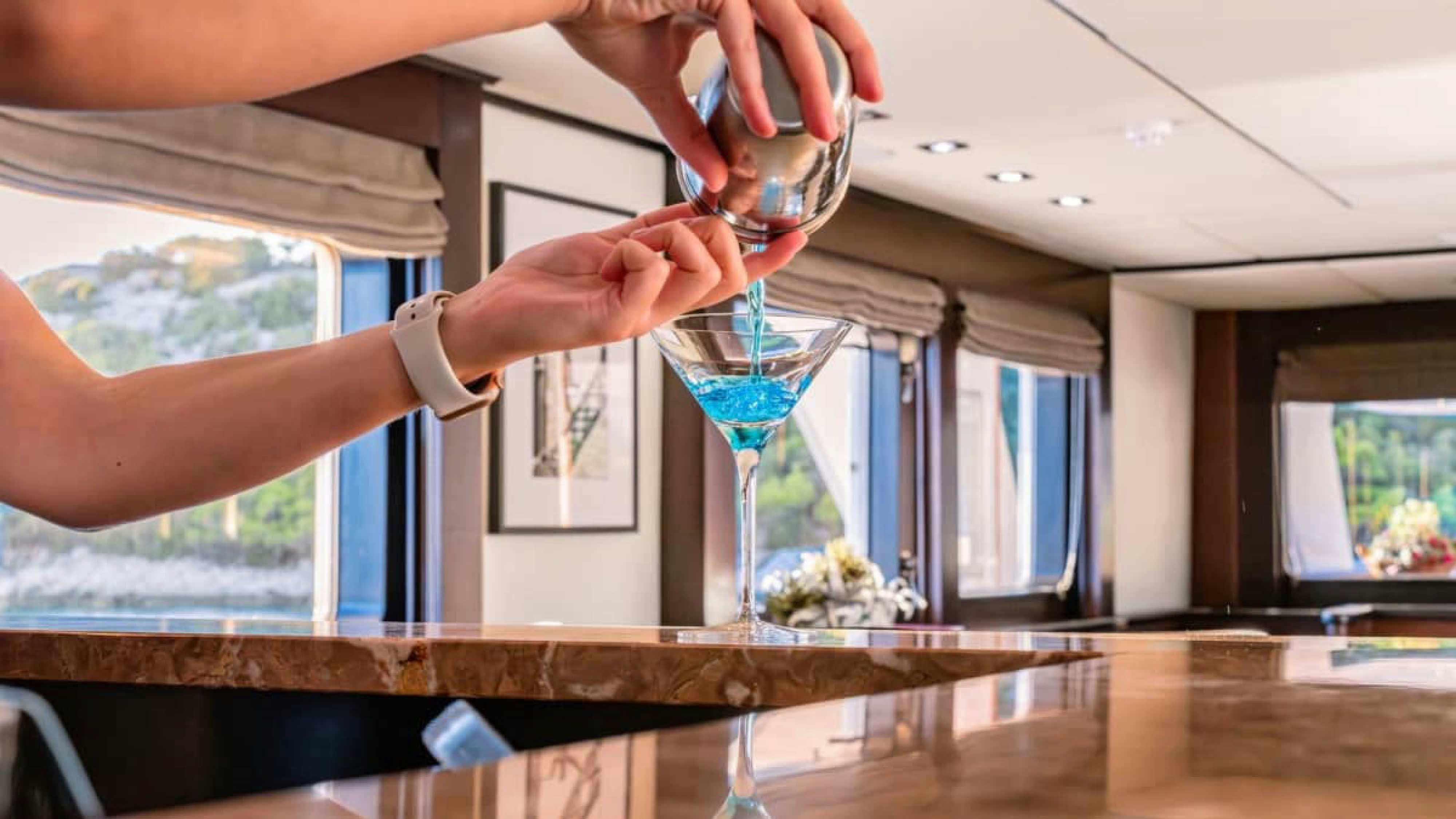 a woman pouring wine into a glass aboard VICTORY Yacht for Charter