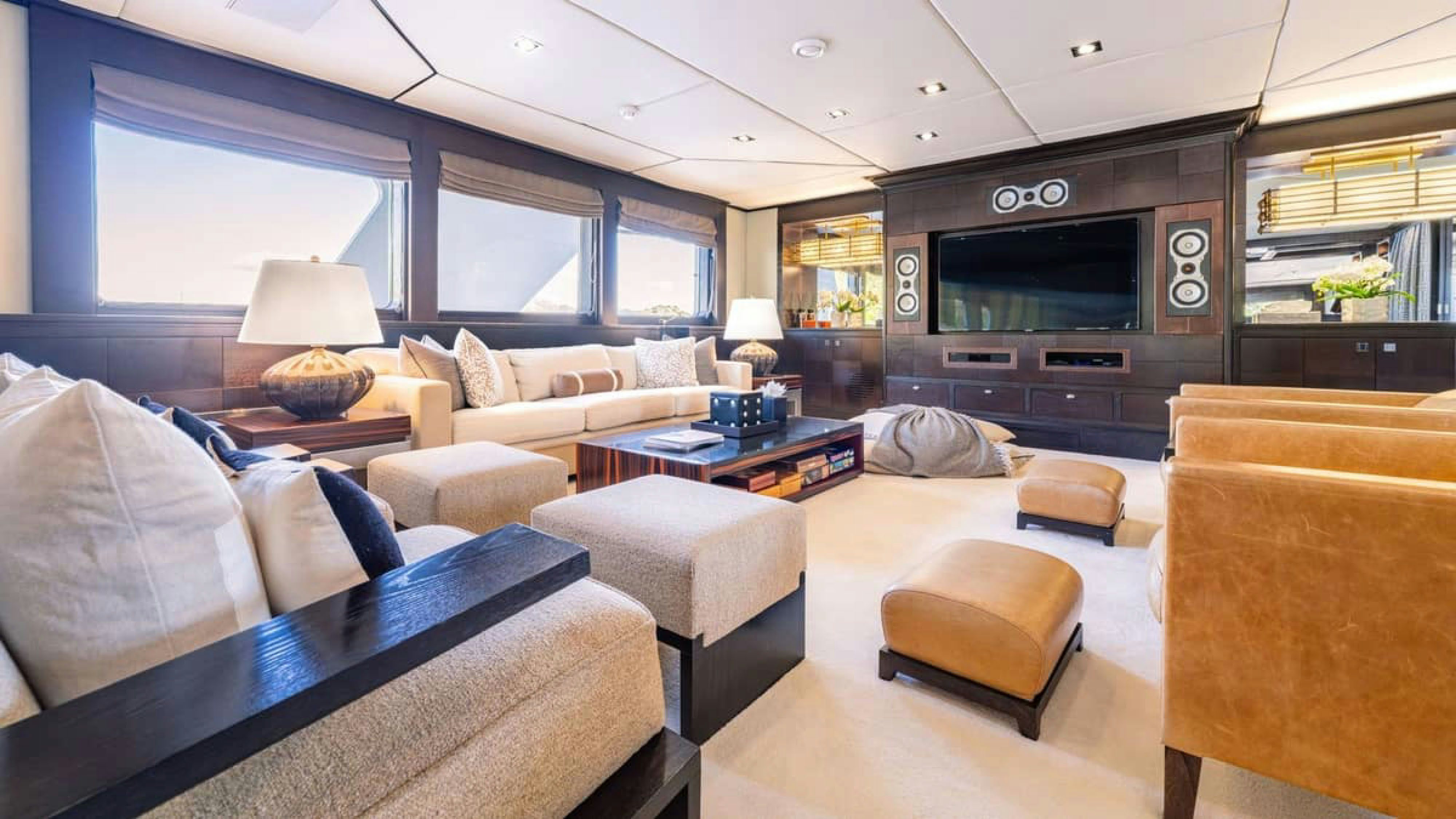 a living room with a couch and a tv aboard VICTORY Yacht for Charter