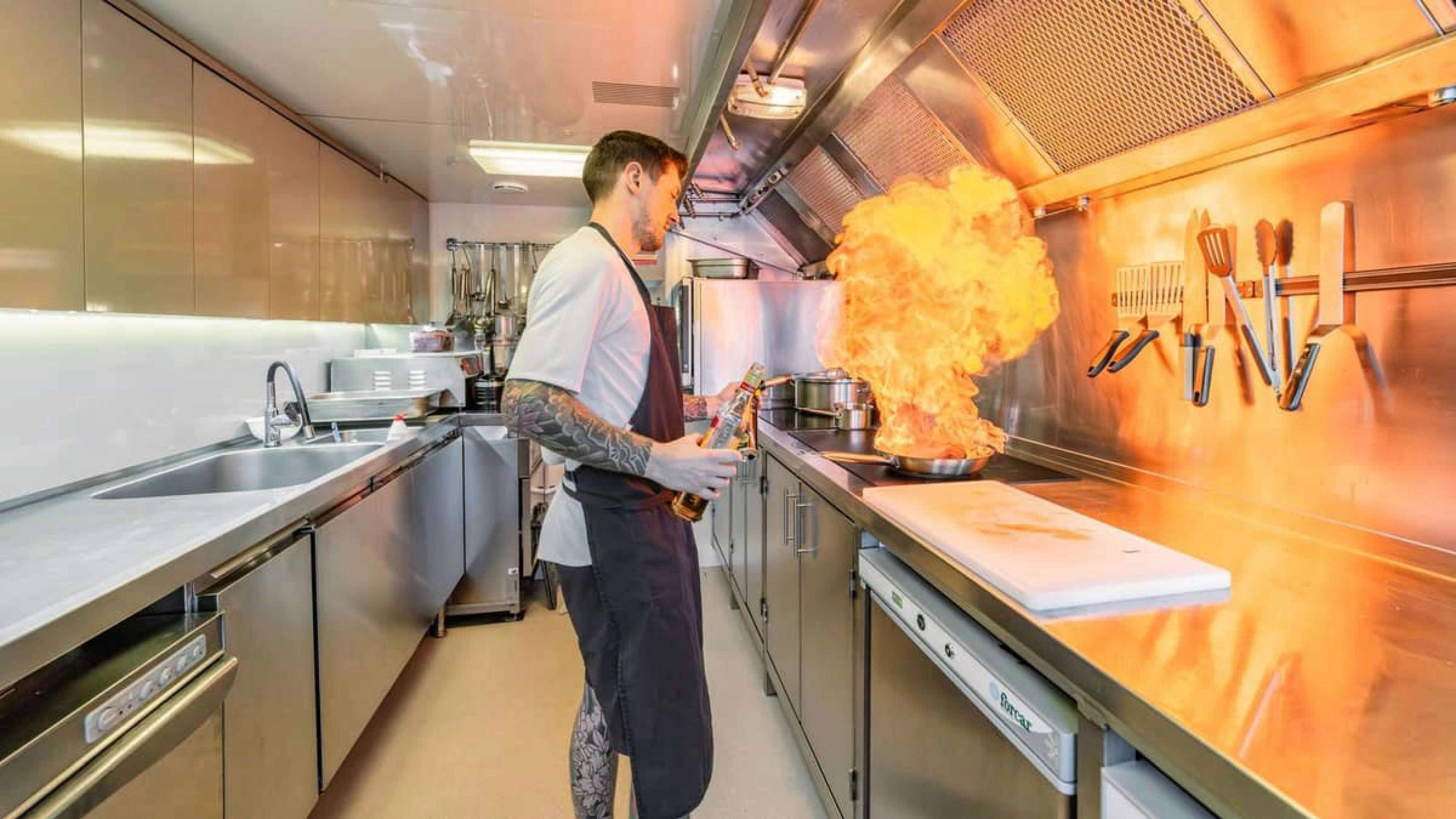 a person cooking in a kitchen aboard VICTORY Yacht for Charter