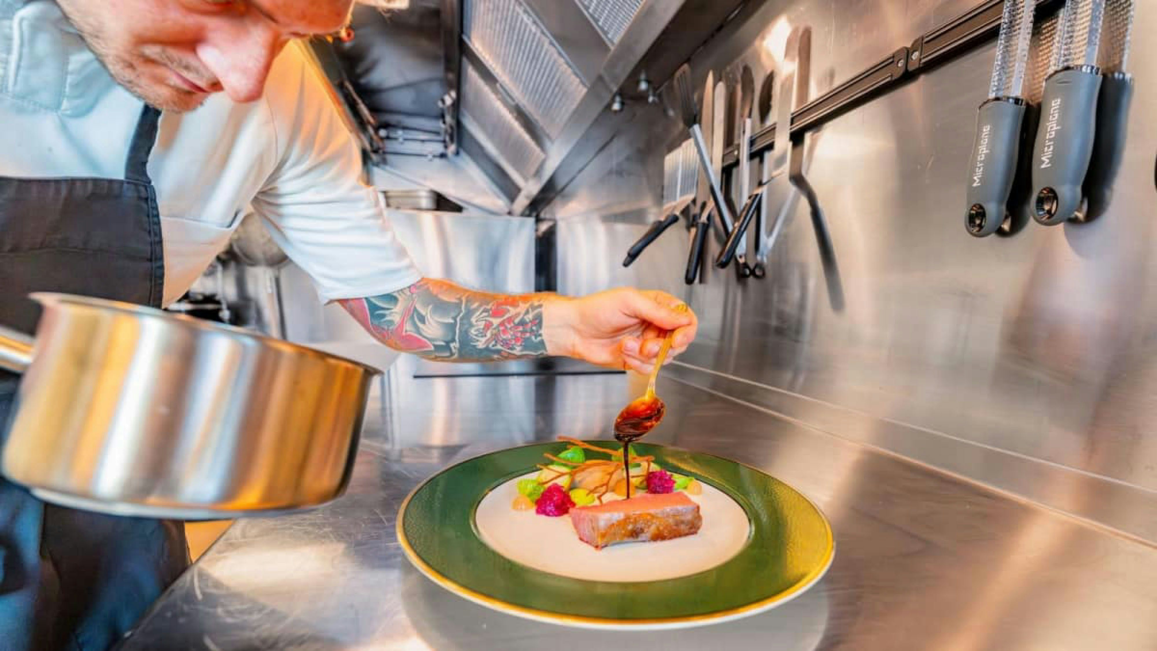 a chef preparing food in a kitchen aboard VICTORY Yacht for Charter
