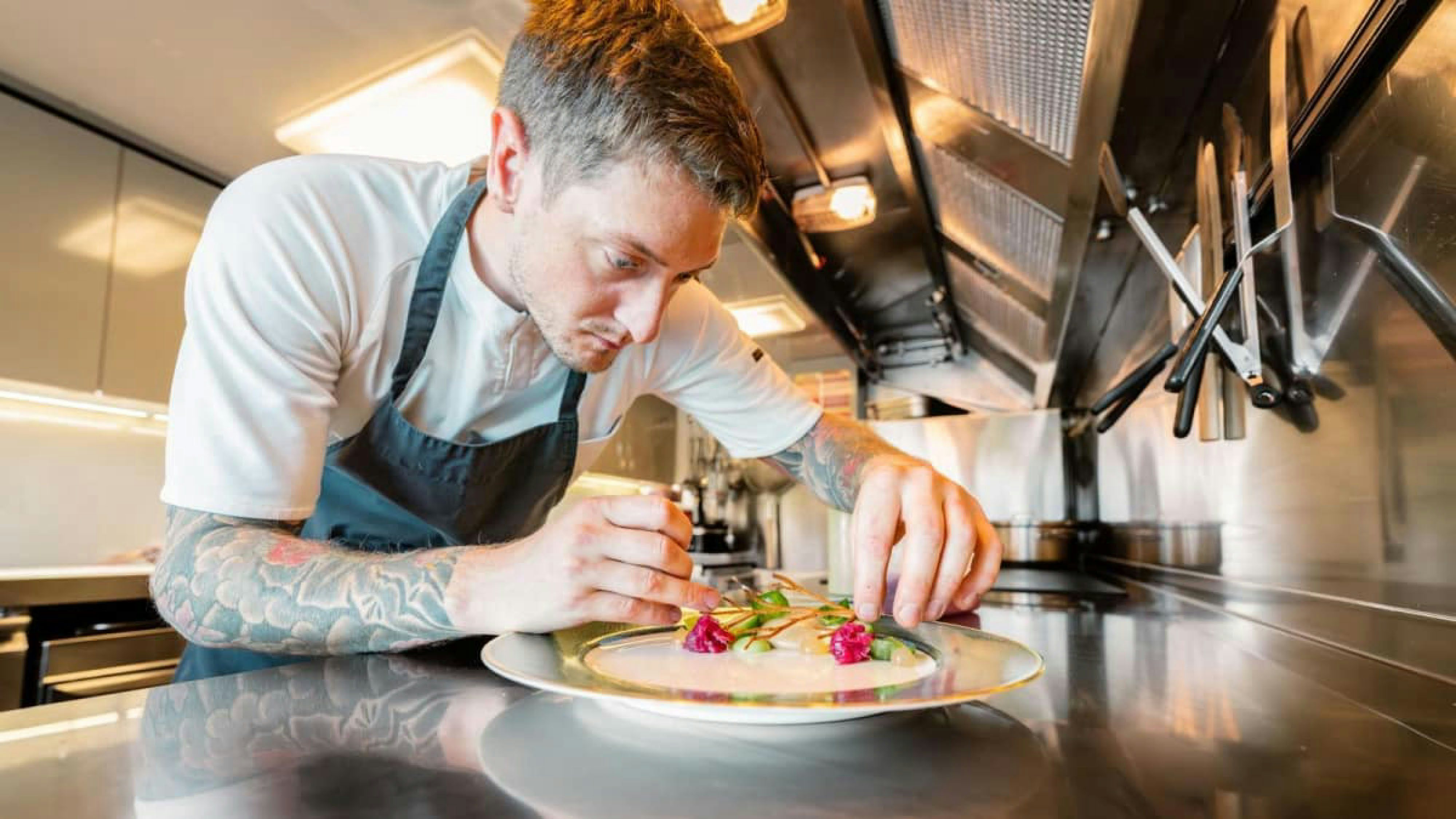 a man preparing a dish aboard VICTORY Yacht for Charter