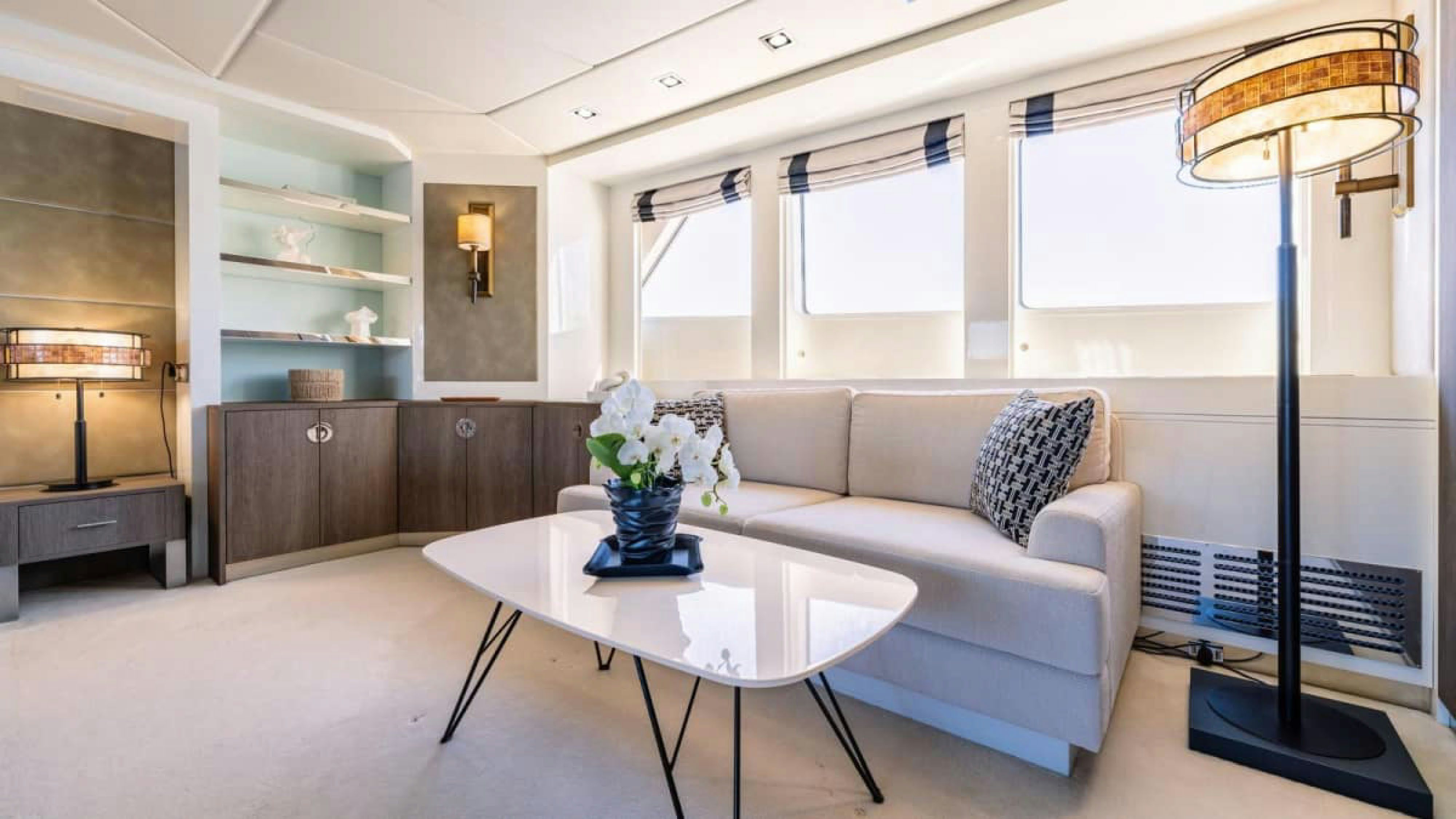 a living room with a white couch and a table aboard VICTORY Yacht for Charter