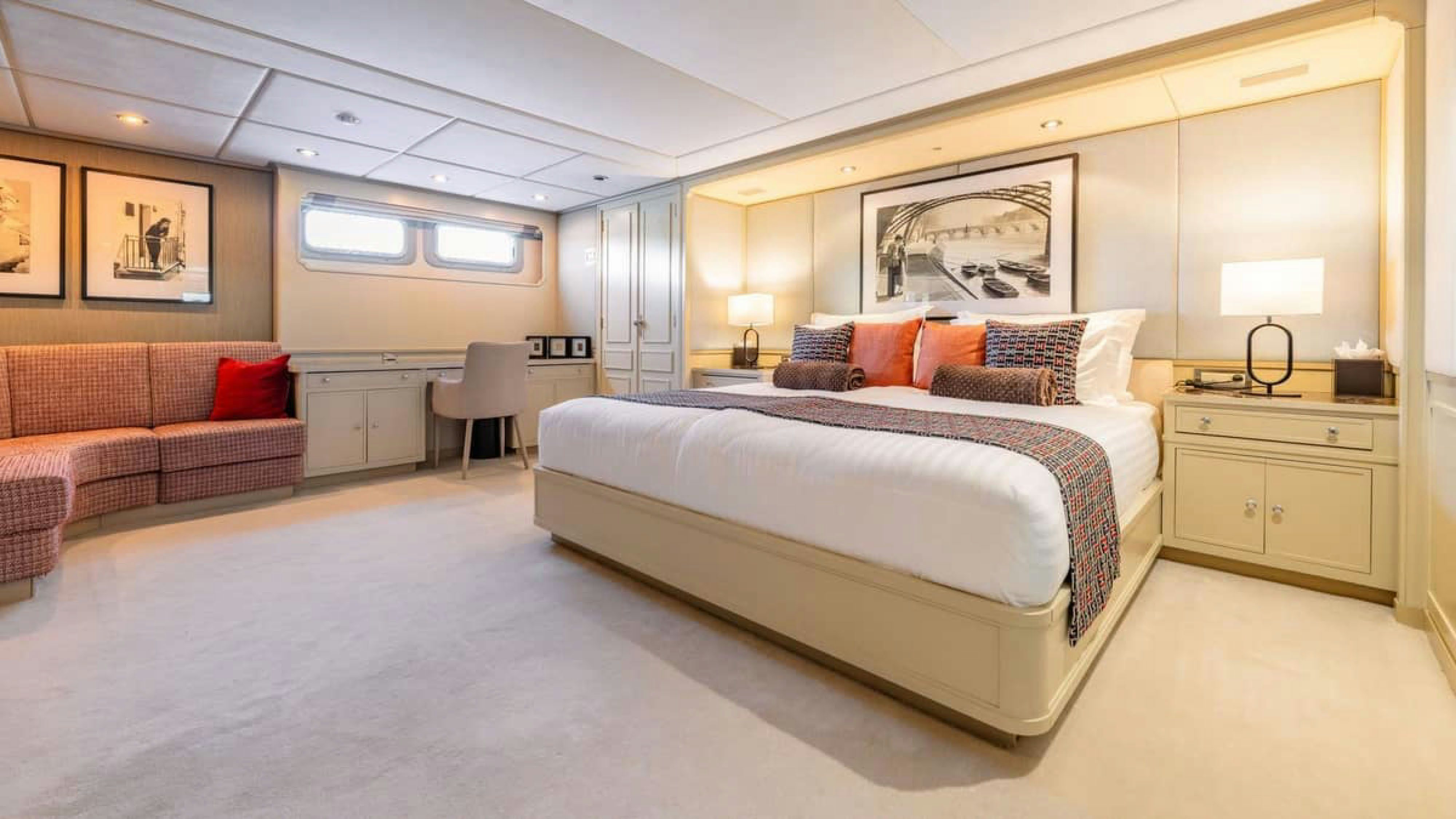 a large bedroom with a bed and a couch aboard VICTORY Yacht for Charter