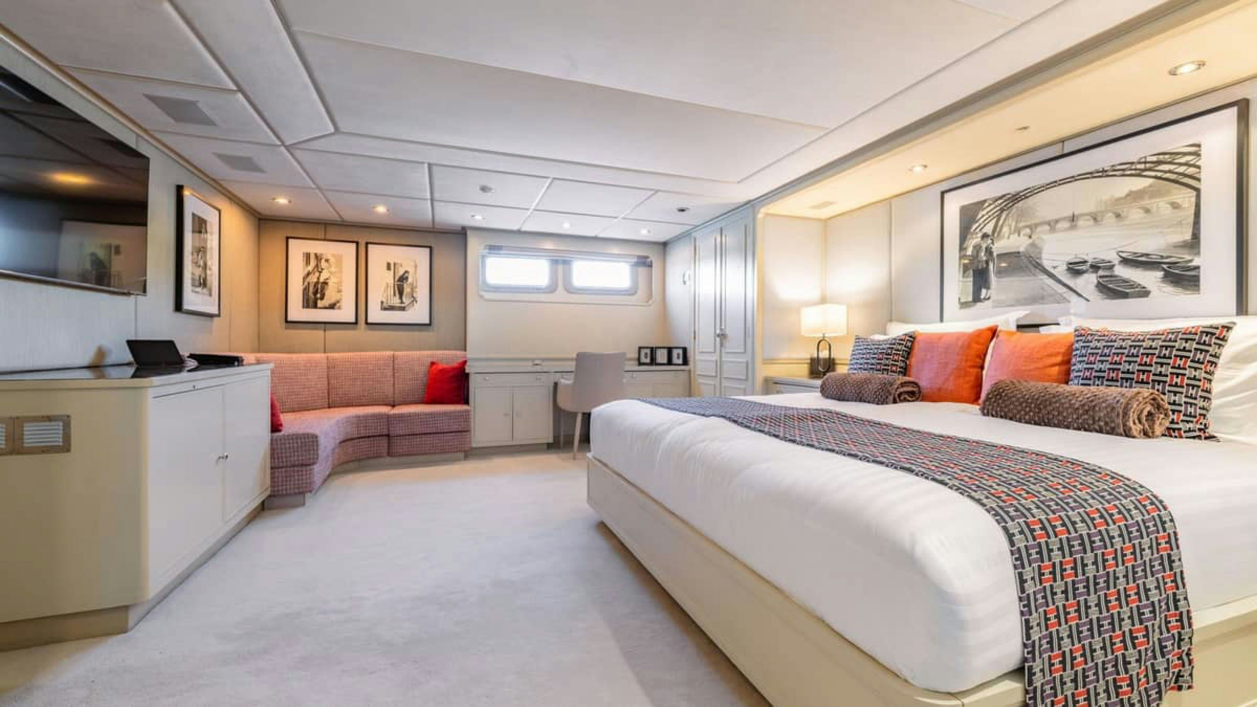 a bedroom with a bed and a couch aboard VICTORY Yacht for Charter