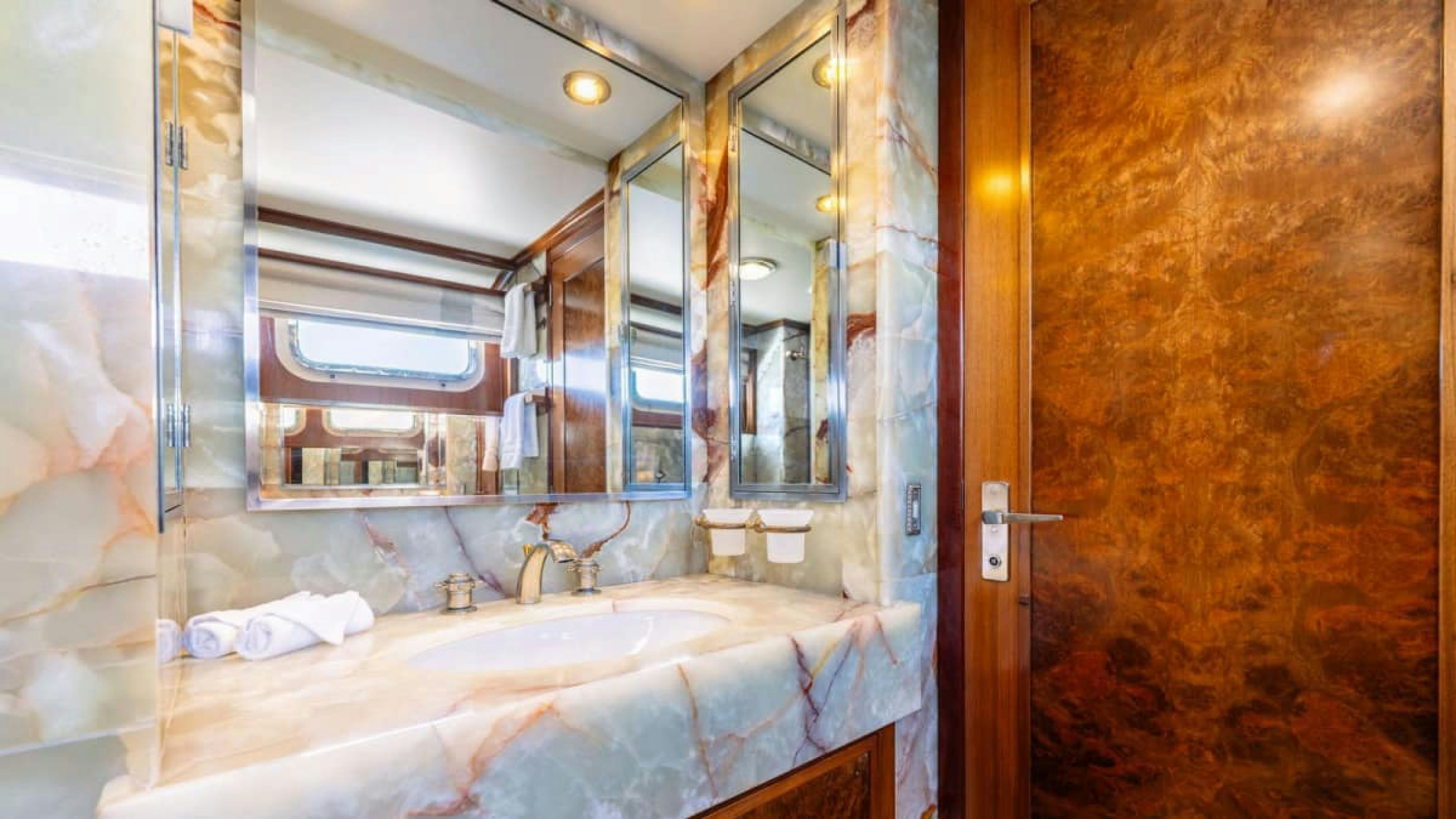 a bathtub and a mirror in a bathroom aboard VICTORY Yacht for Charter