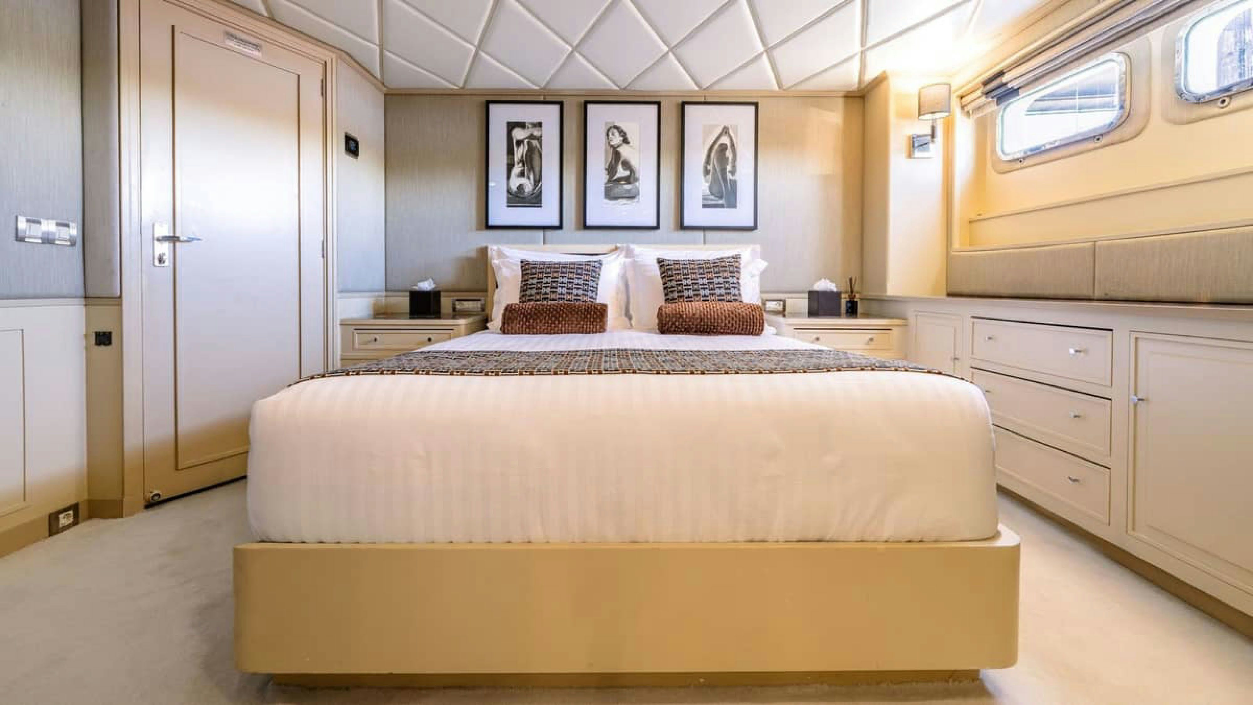 a room with a bed and a desk aboard VICTORY Yacht for Charter