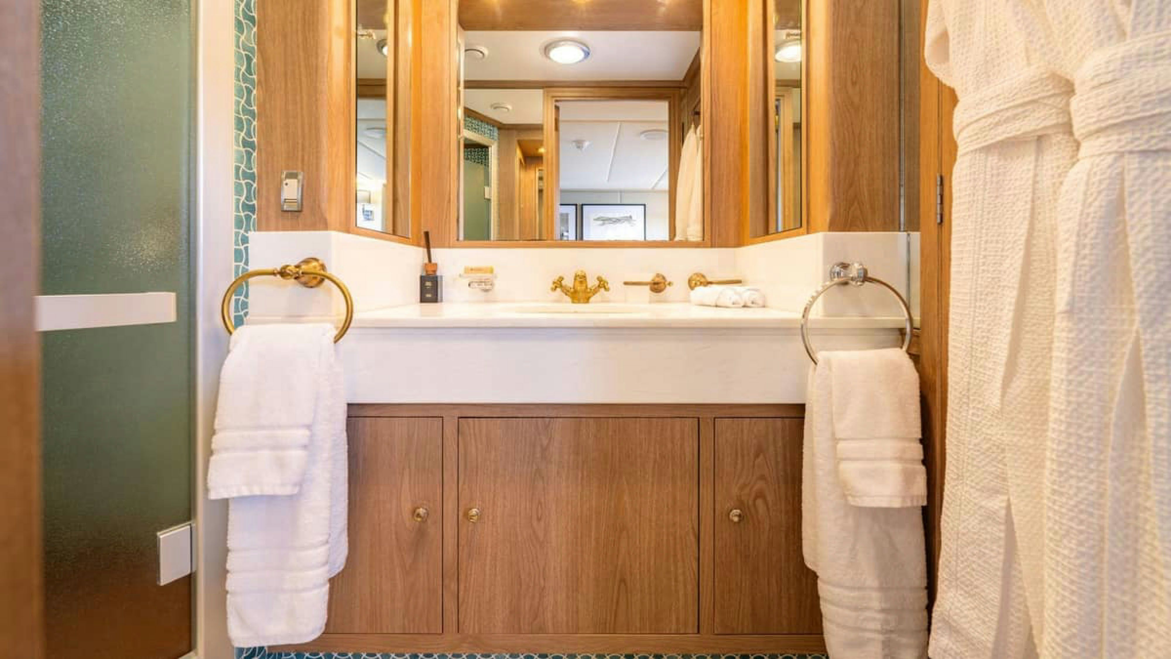 a bathroom with a mirror and a sink aboard VICTORY Yacht for Charter