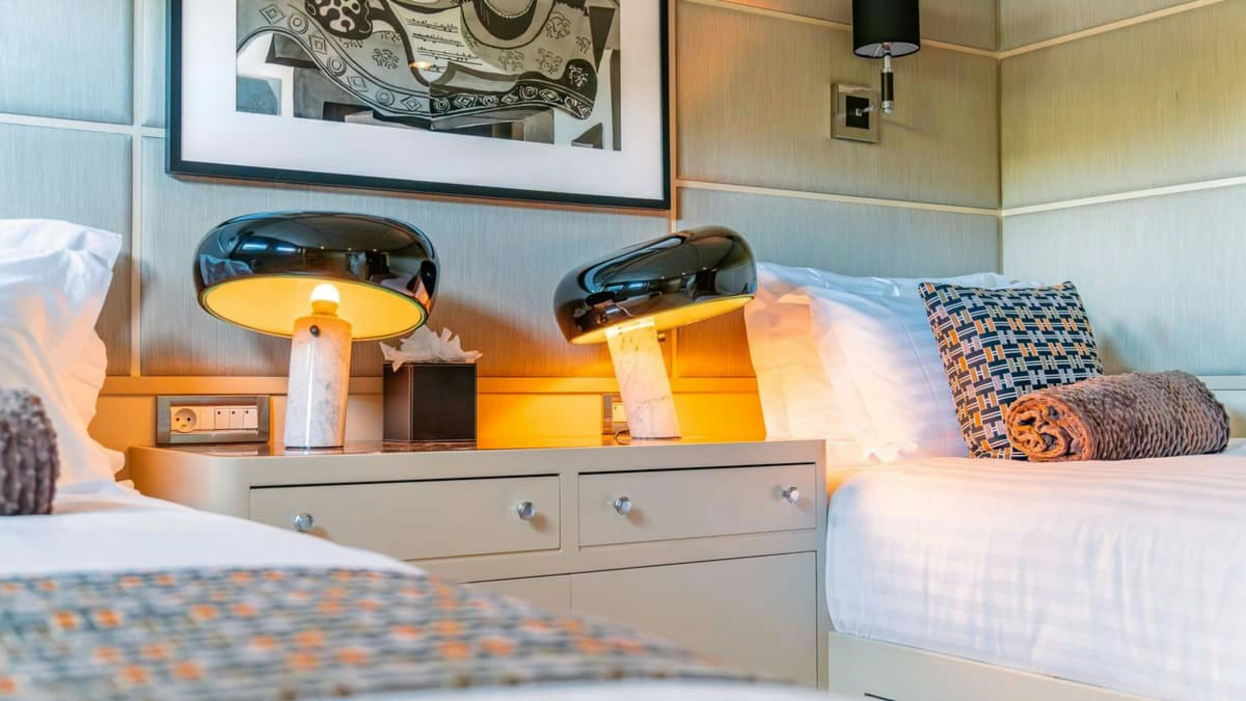 a bed with a yellow hat on top of it aboard VICTORY Yacht for Charter