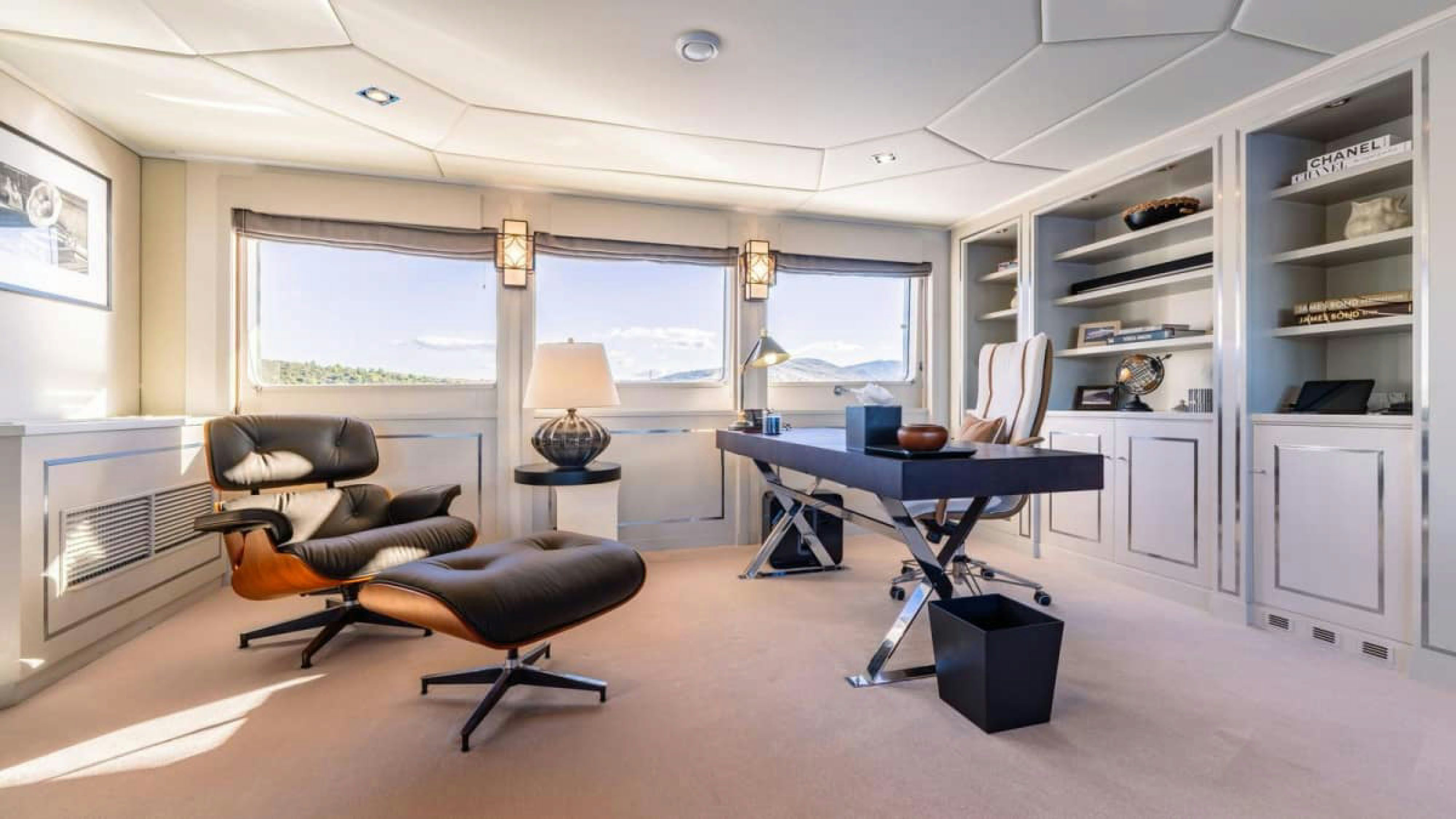 a room with a couch and a table and a lamp aboard VICTORY Yacht for Charter