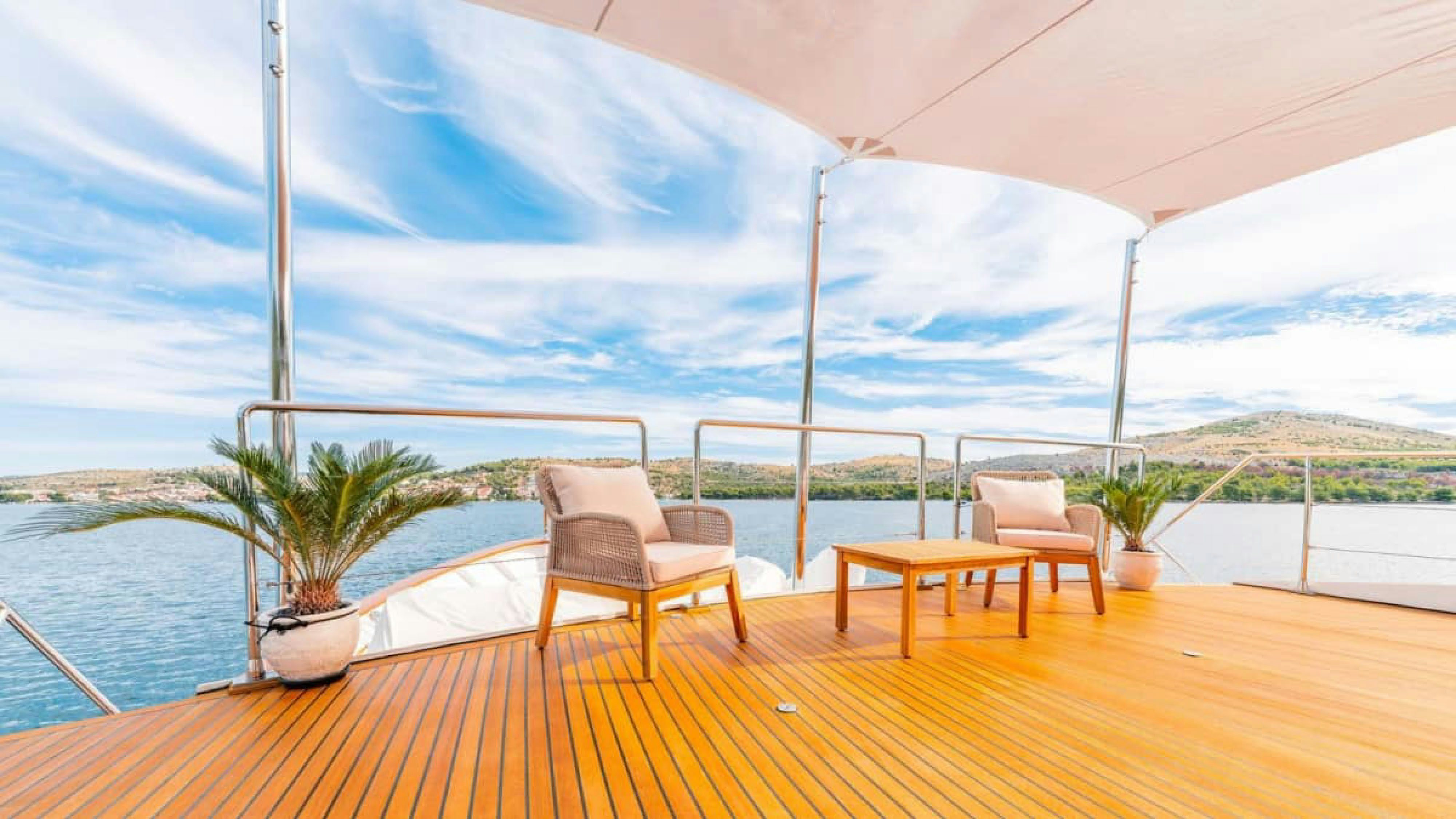 a table and chairs on a deck aboard VICTORY Yacht for Charter