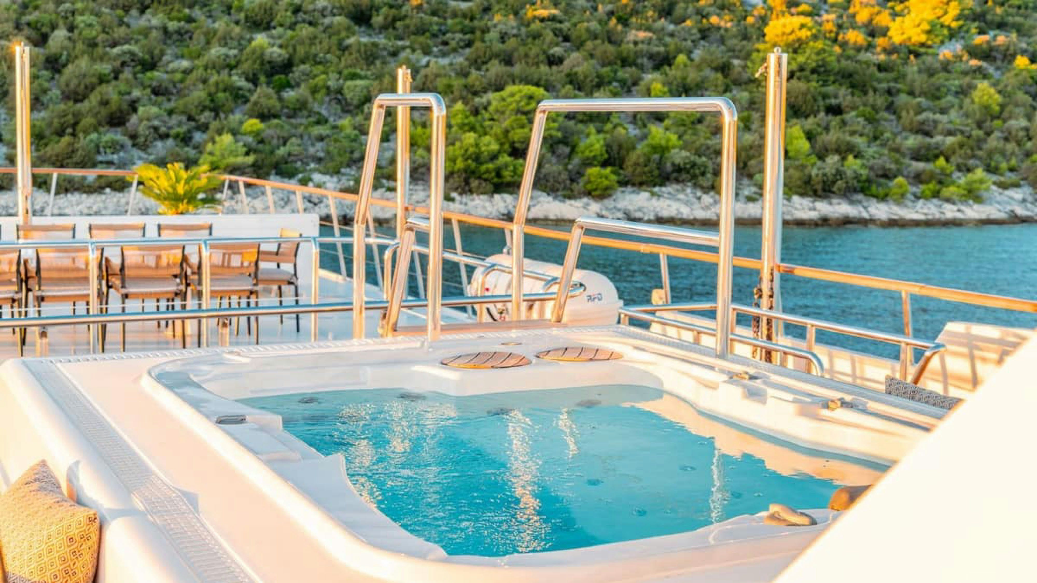 a swimming pool with chairs and tables aboard VICTORY Yacht for Charter